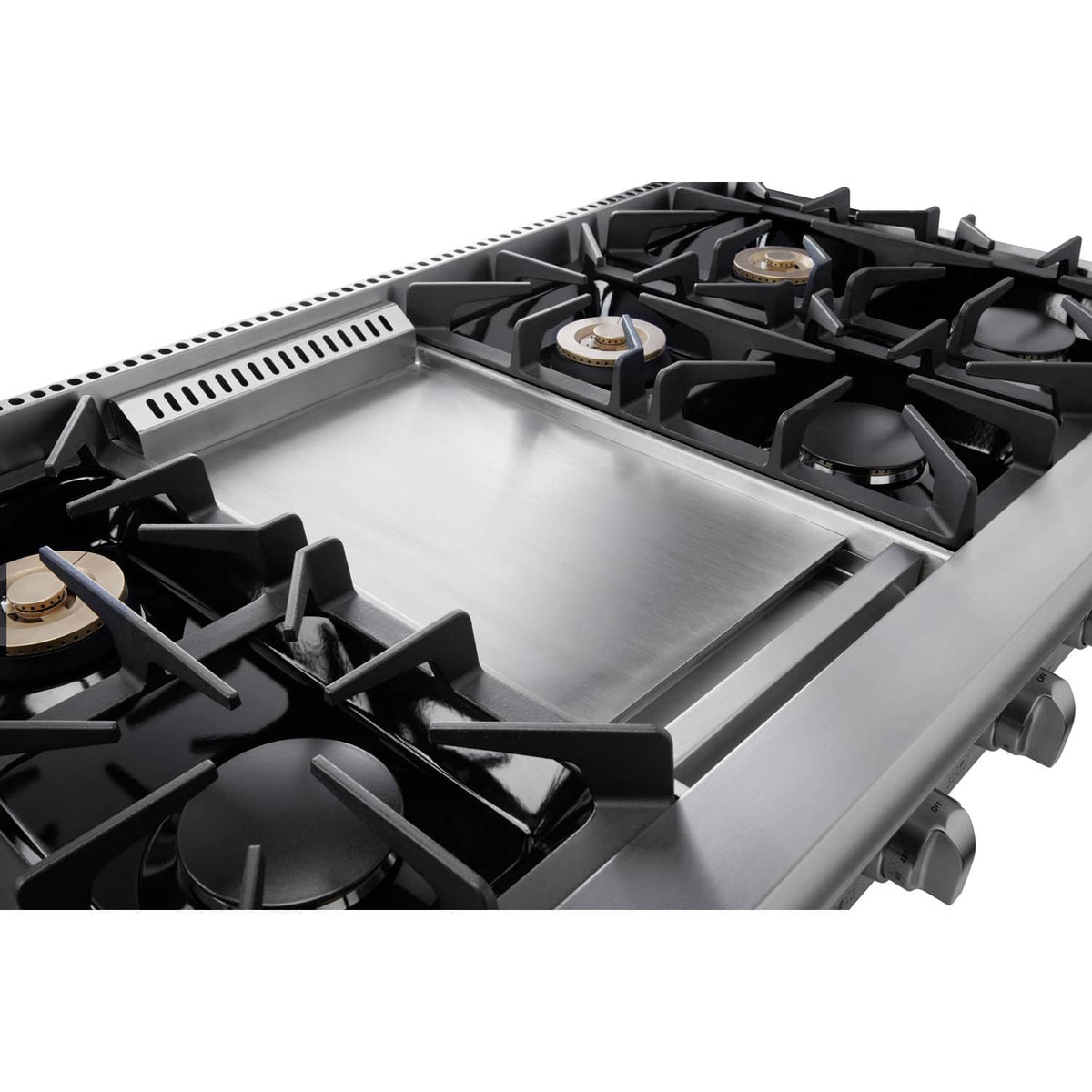 Gas range cooktop close-up with black grates and burner caps on stainless base
