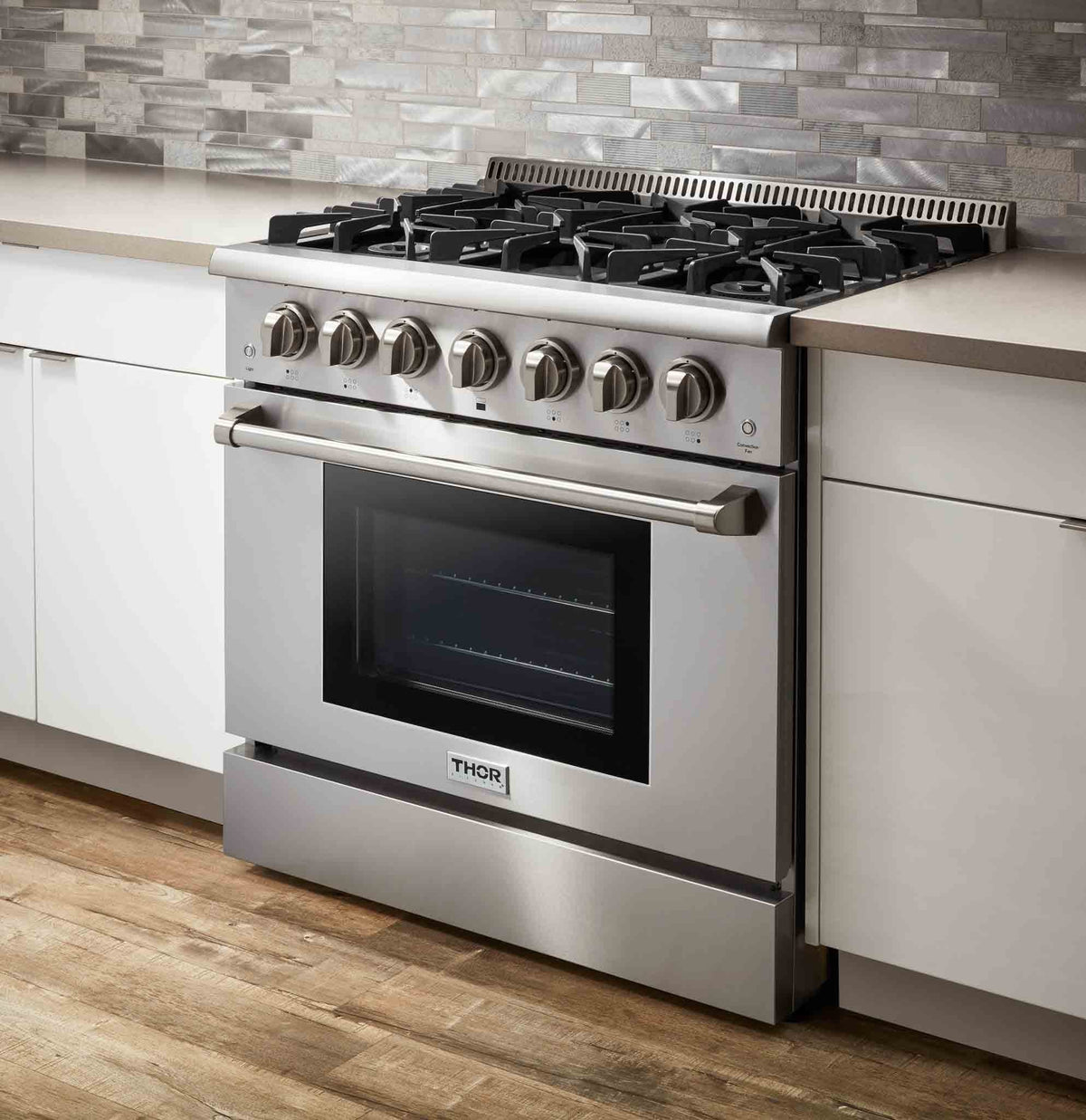 Stainless steel 36-inch gas range with control knobs and cooktop grates