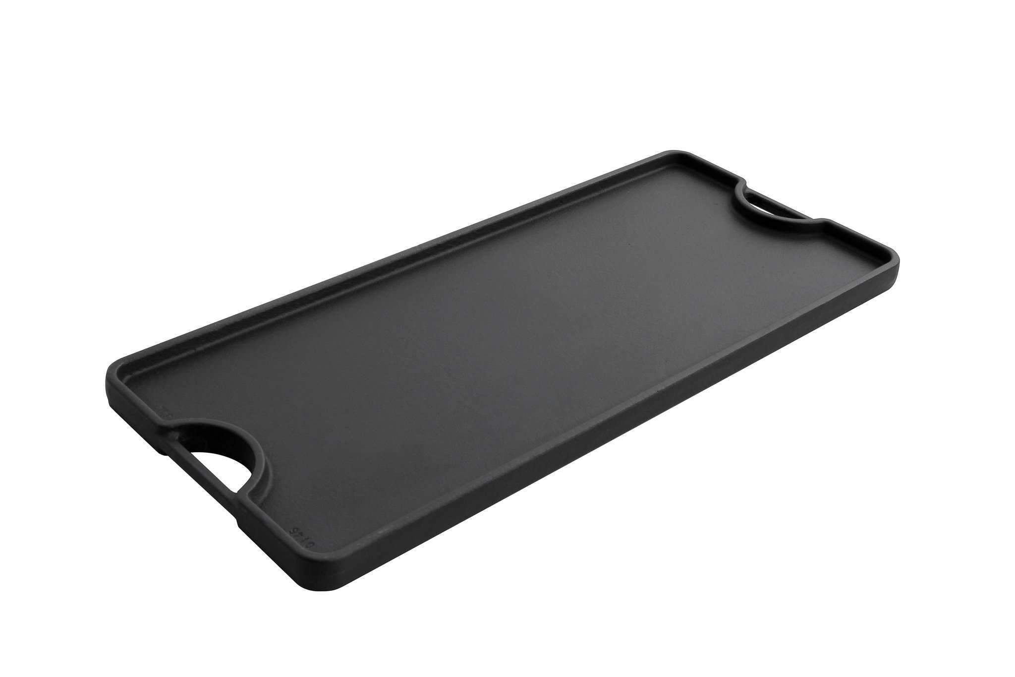 Black cast iron reversible griddle with smooth flat cooking surface and side handles