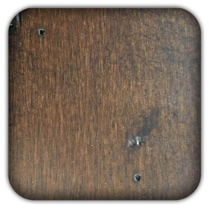 Brown wood sample board with visible grain and small drilled holes