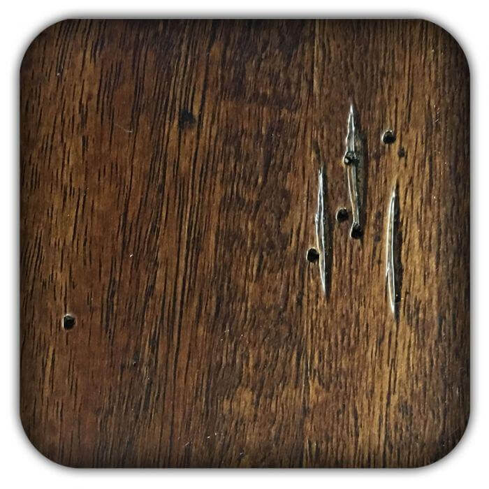 Walnut wood sample board with dark grain and metal fasteners