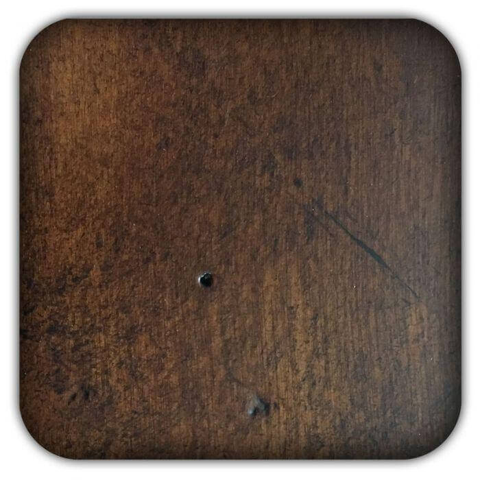 Dark brown wood sample board with rounded corners, visible grain and small holes