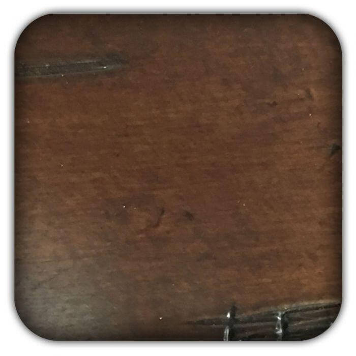 Walnut wood sample card with dark brown grain texture, rounded corners