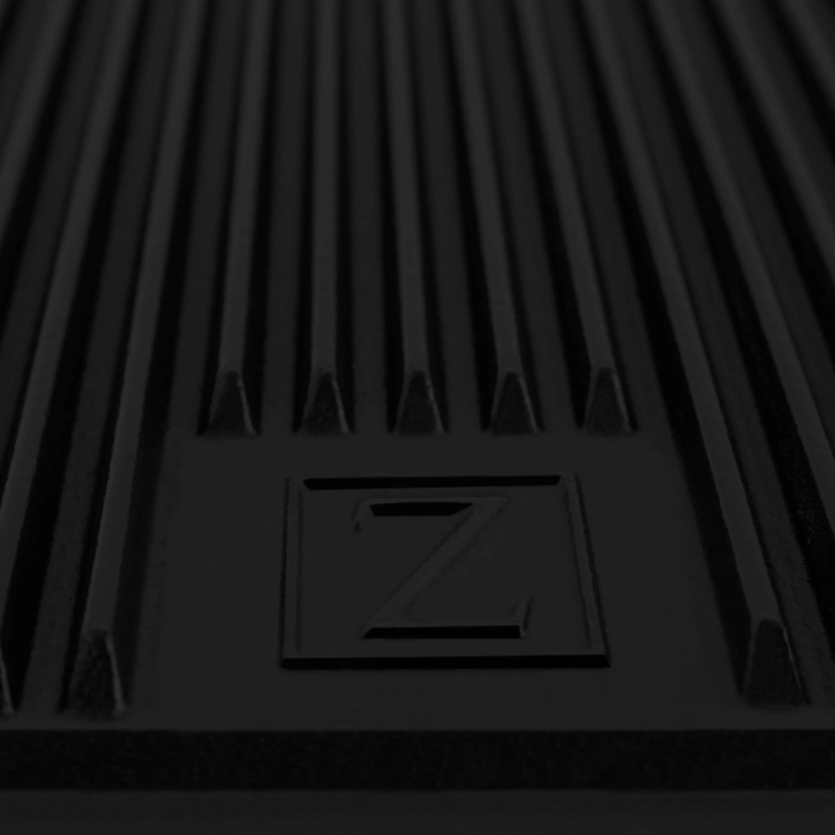 Reversible cast iron griddle insert with flat cooking surface and embossed Z icon