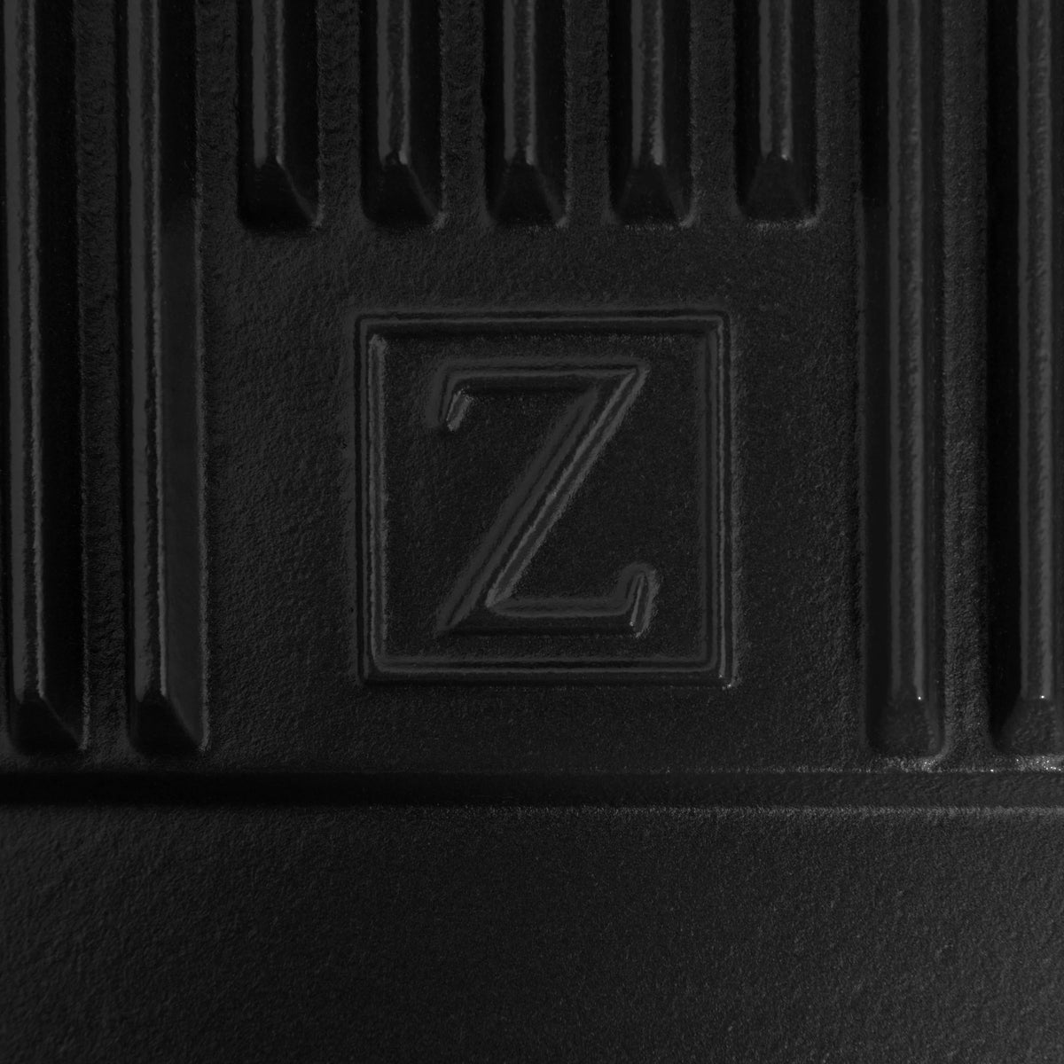Reversible cast iron griddle insert flat side with embossed Z logo and textured surface