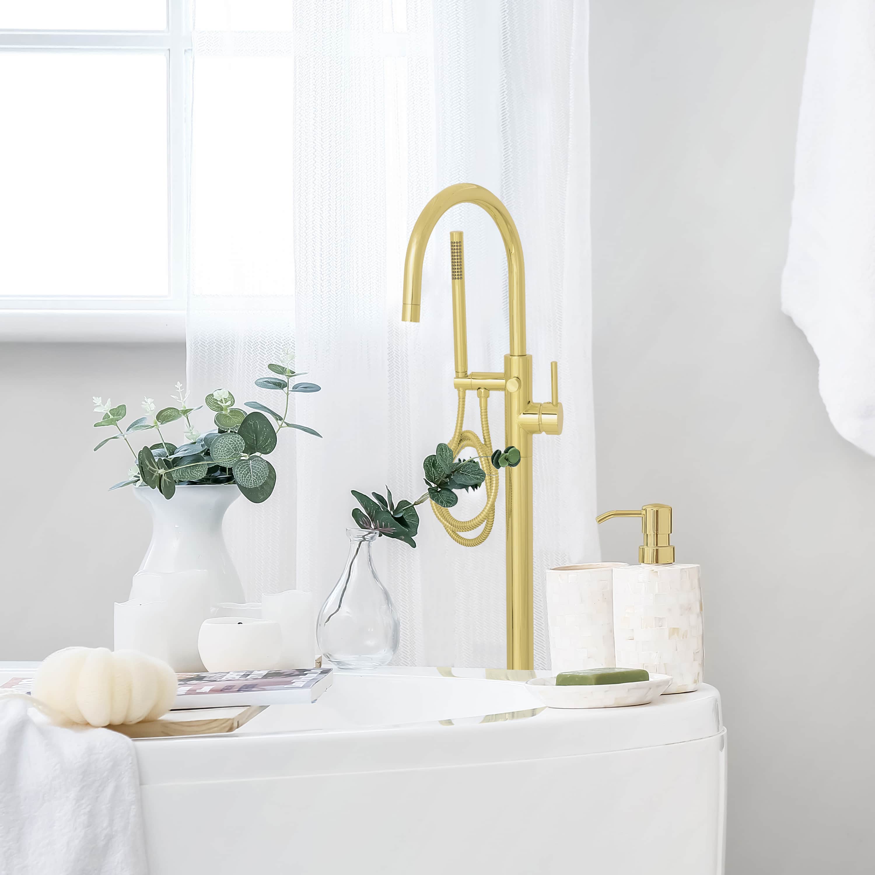 Polished gold bath tub faucet set with arched spout and handheld sprayer, deck-mounted