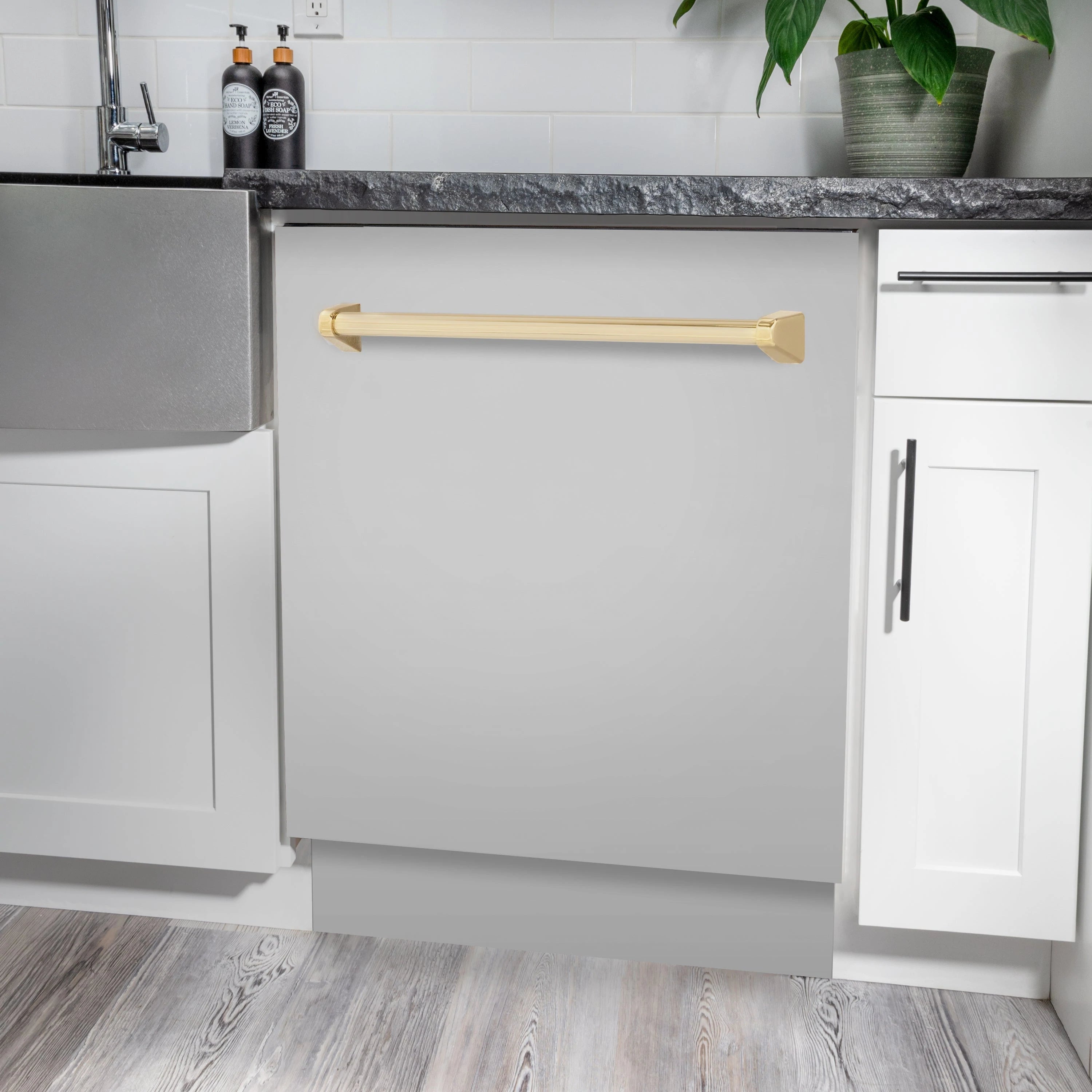 Tall white built-in dishwasher with gold handle, front door open in kitchen