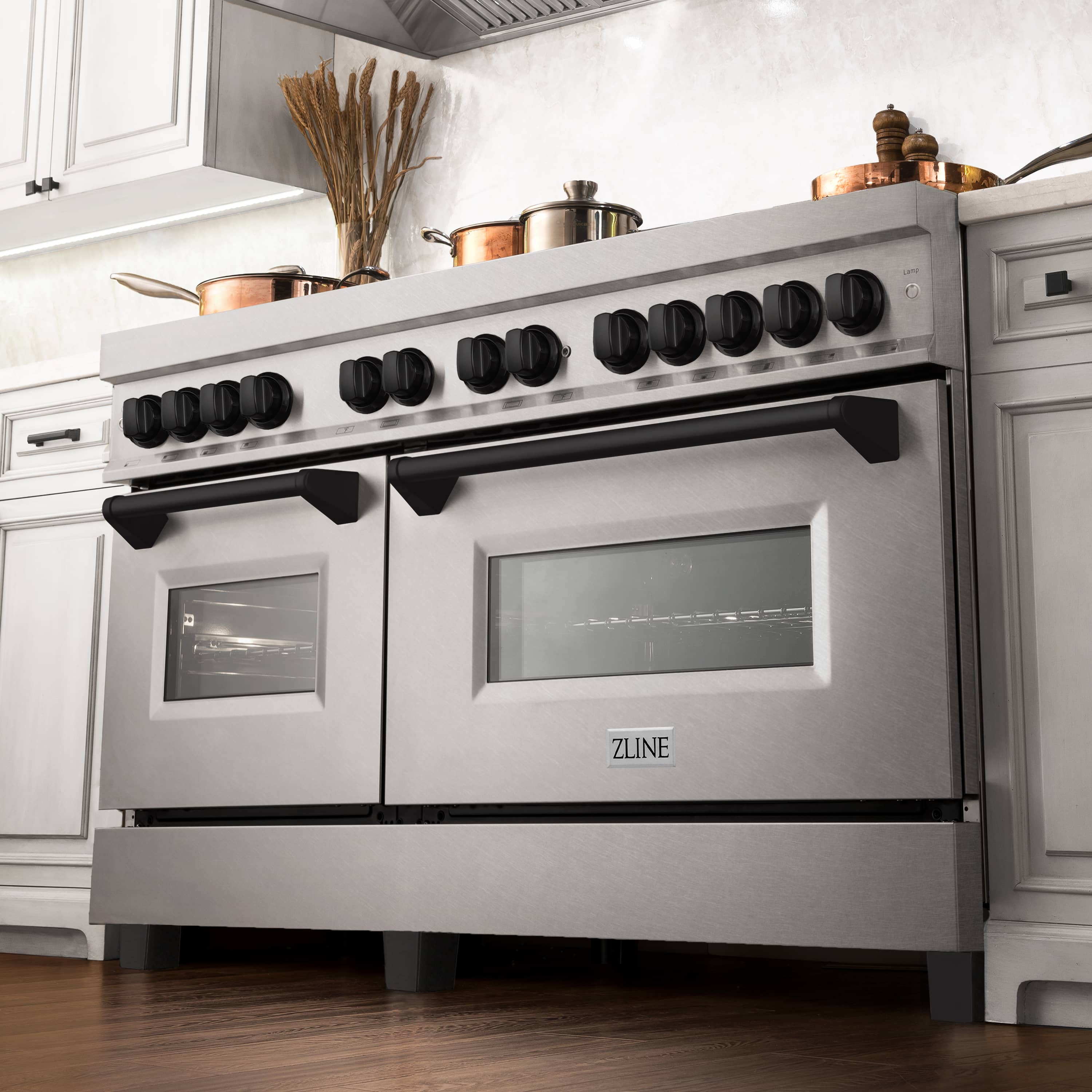 Dual fuel range front with satin stainless steel doors, black control knobs, and windowed ovens
