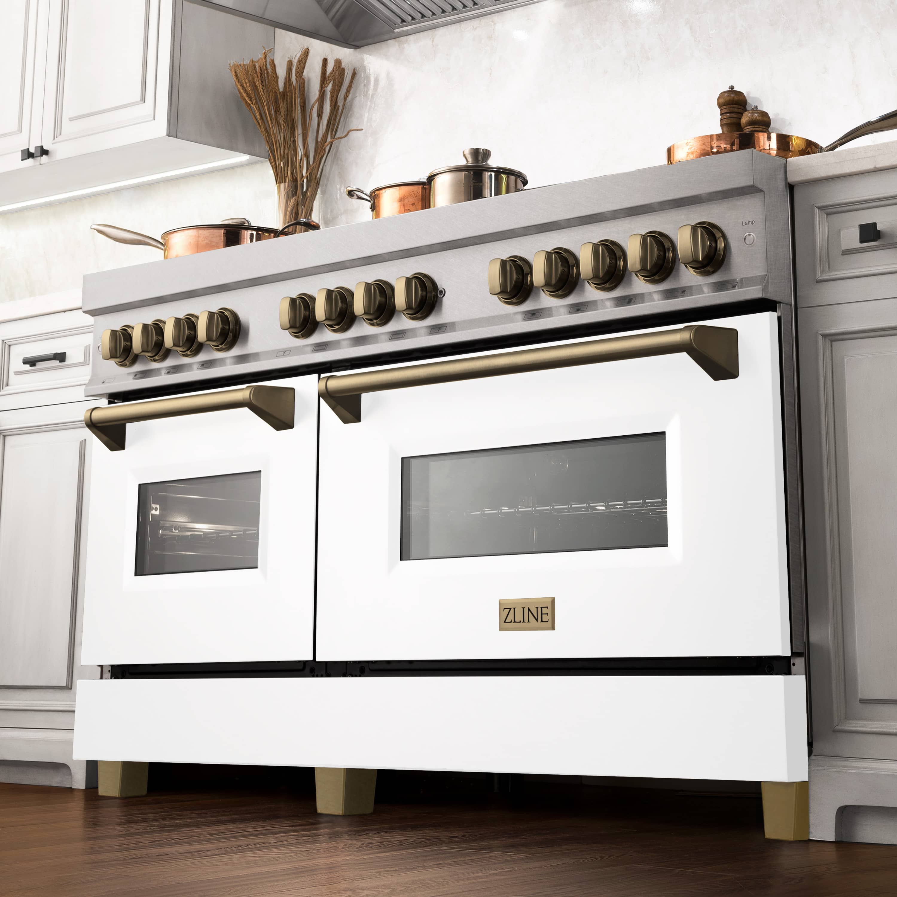 Dual fuel range with white matte doors, satin stainless finish, and bronze control knobs