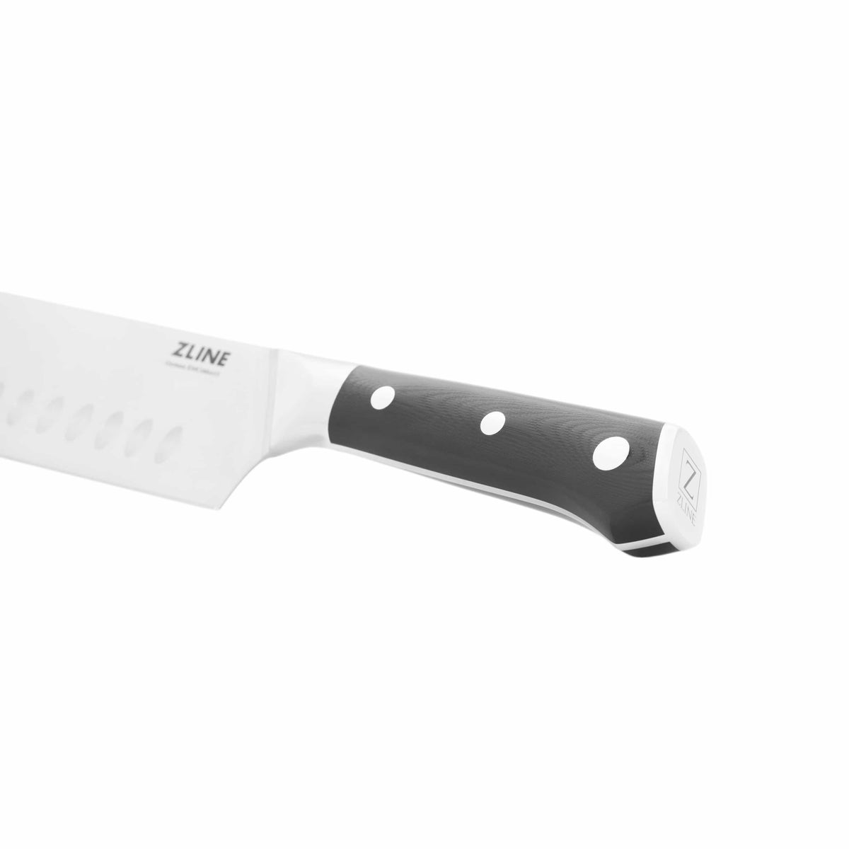 Chef’s knife side view with stainless blade, black handle, and white dot rivets