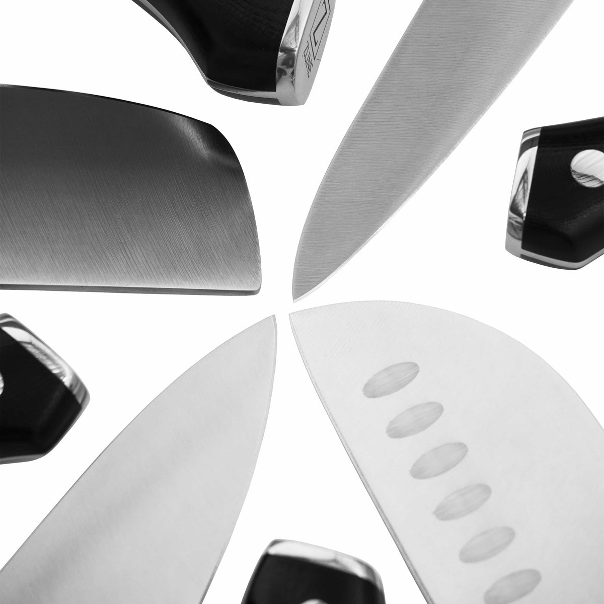 Close-up of multiple kitchen knives with silver blades and black riveted handles