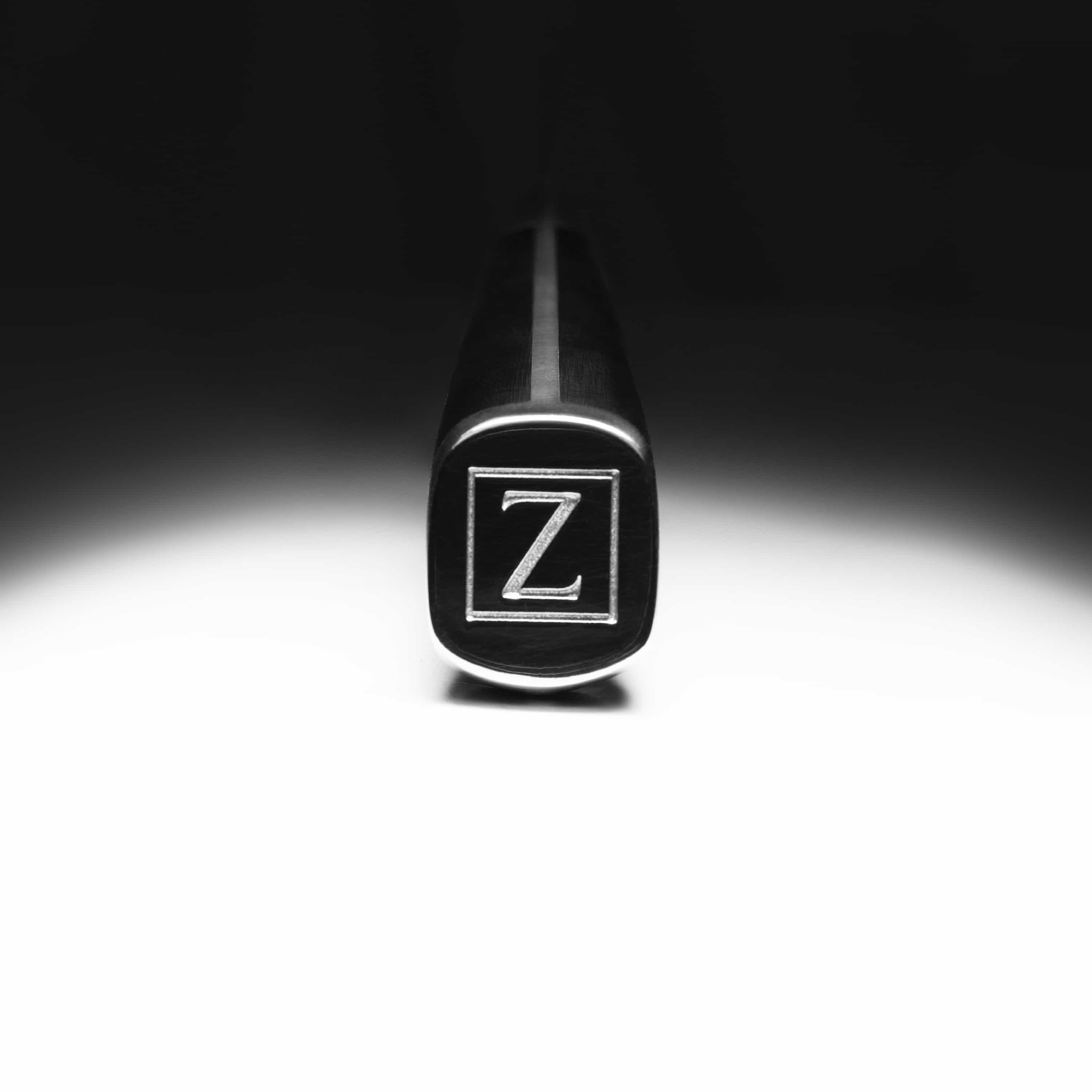 Damascus steel chef’s knife bolster end cap with ZLINE logo on black handle