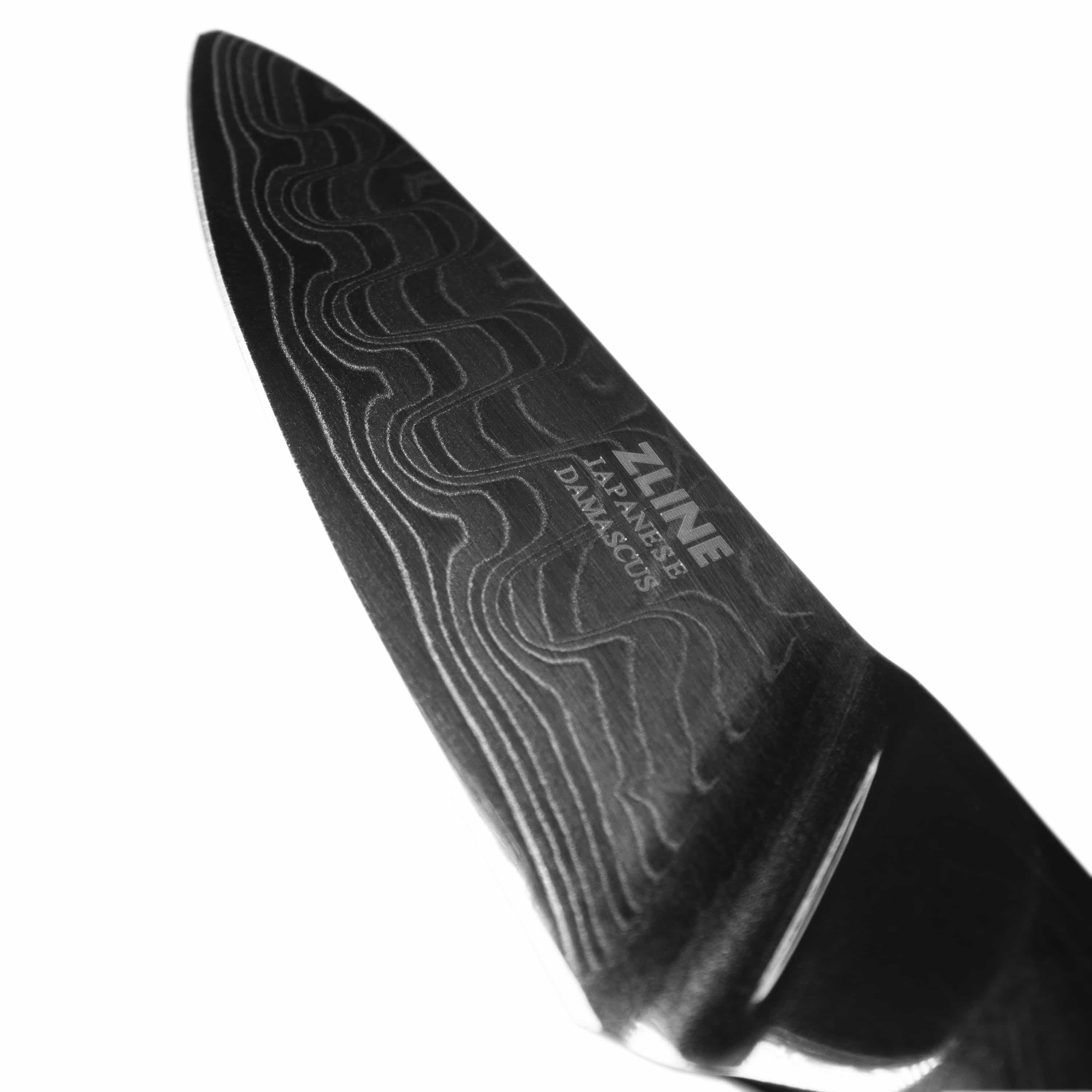 Damascus steel kitchen knife blade close-up with dark wave lines and ZLINE logo