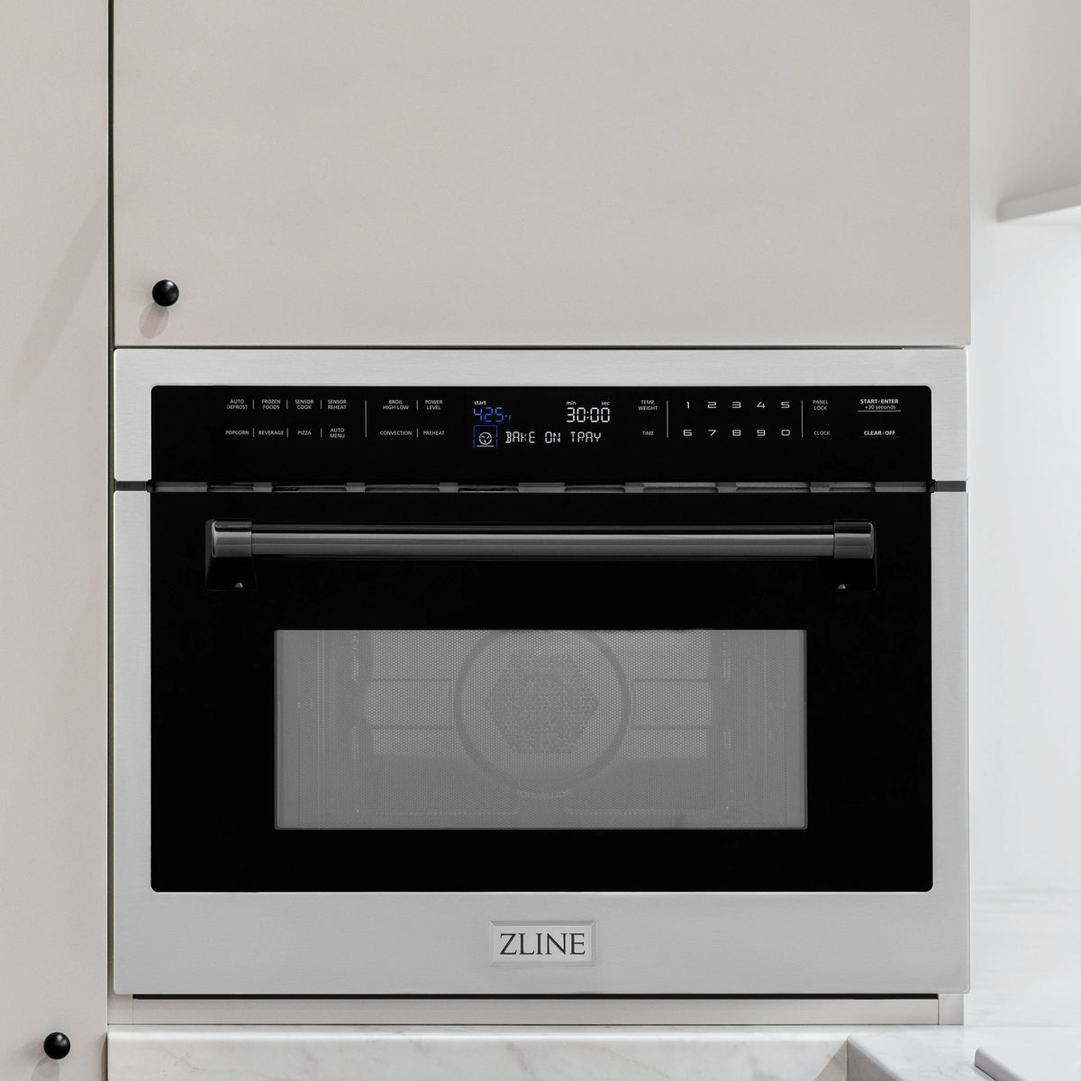 Built-in convection microwave oven front view with black glass door and control keypad.