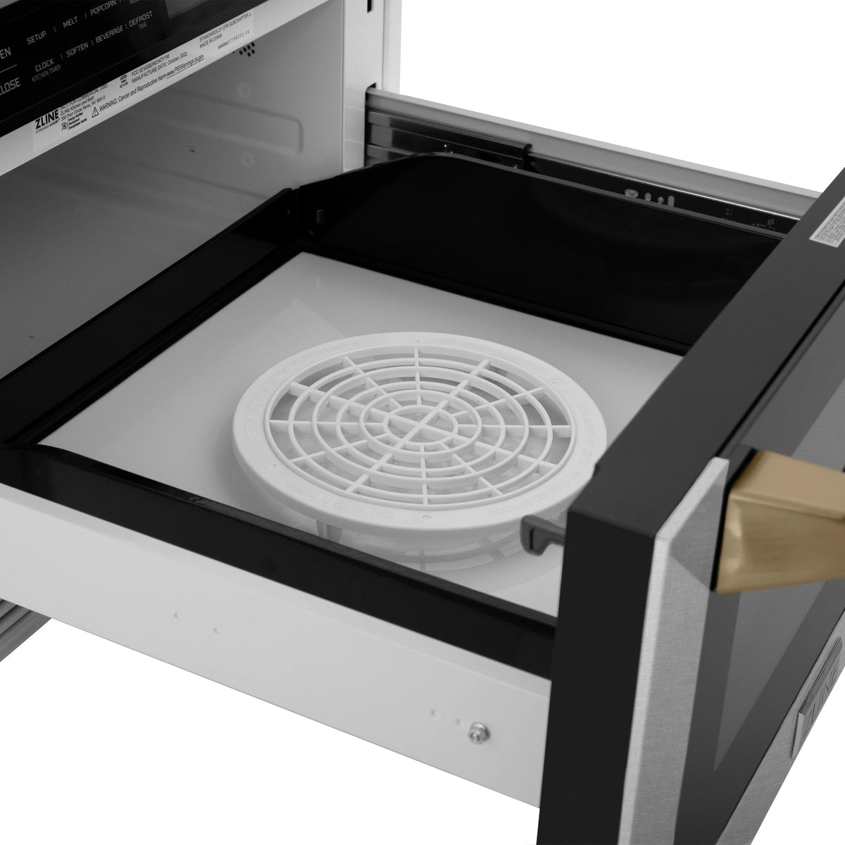 Built-in microwave drawer with turntable plate inside and dark interior walls