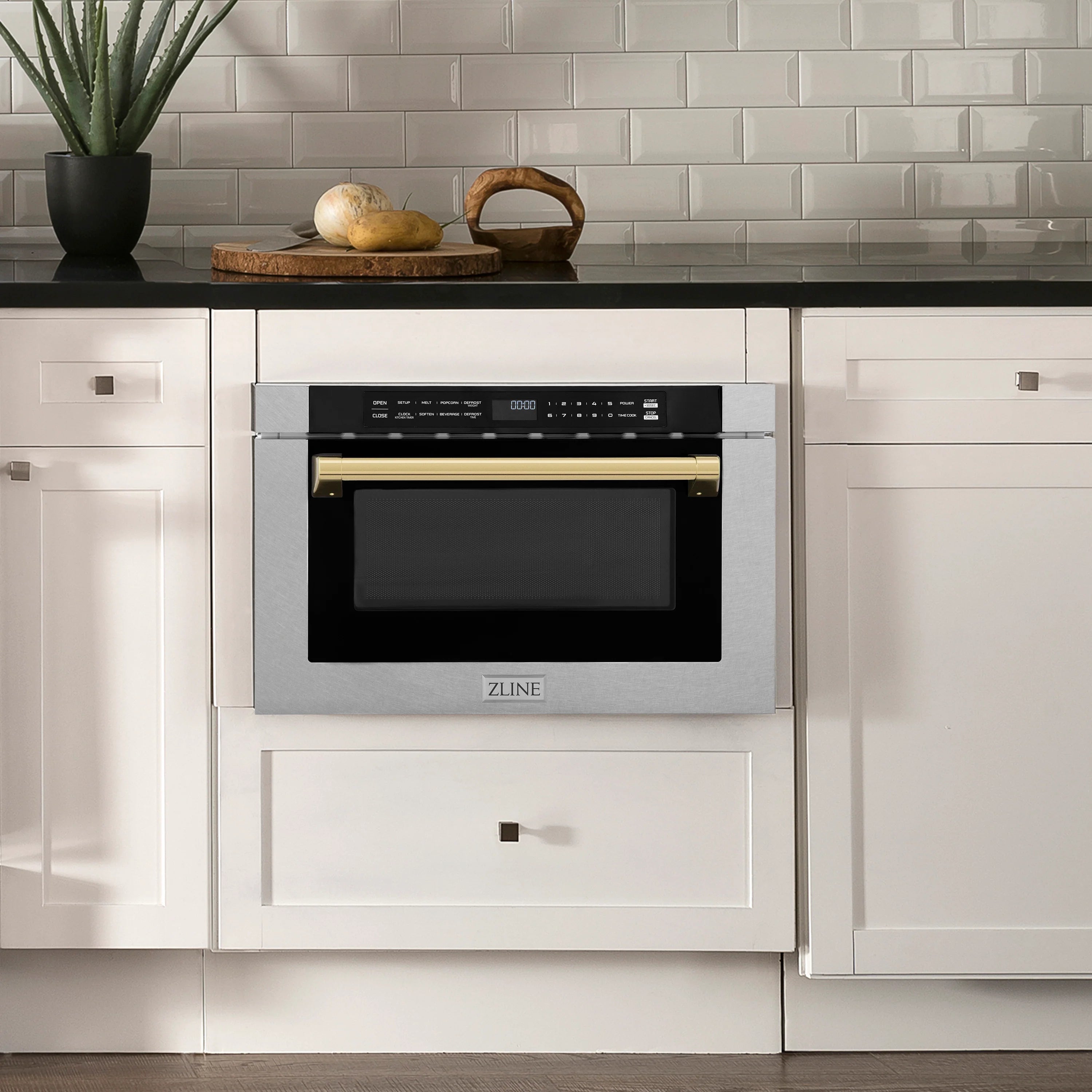 Built-in microwave drawer installed in cabinetry, stainless steel with gold trim and black glass