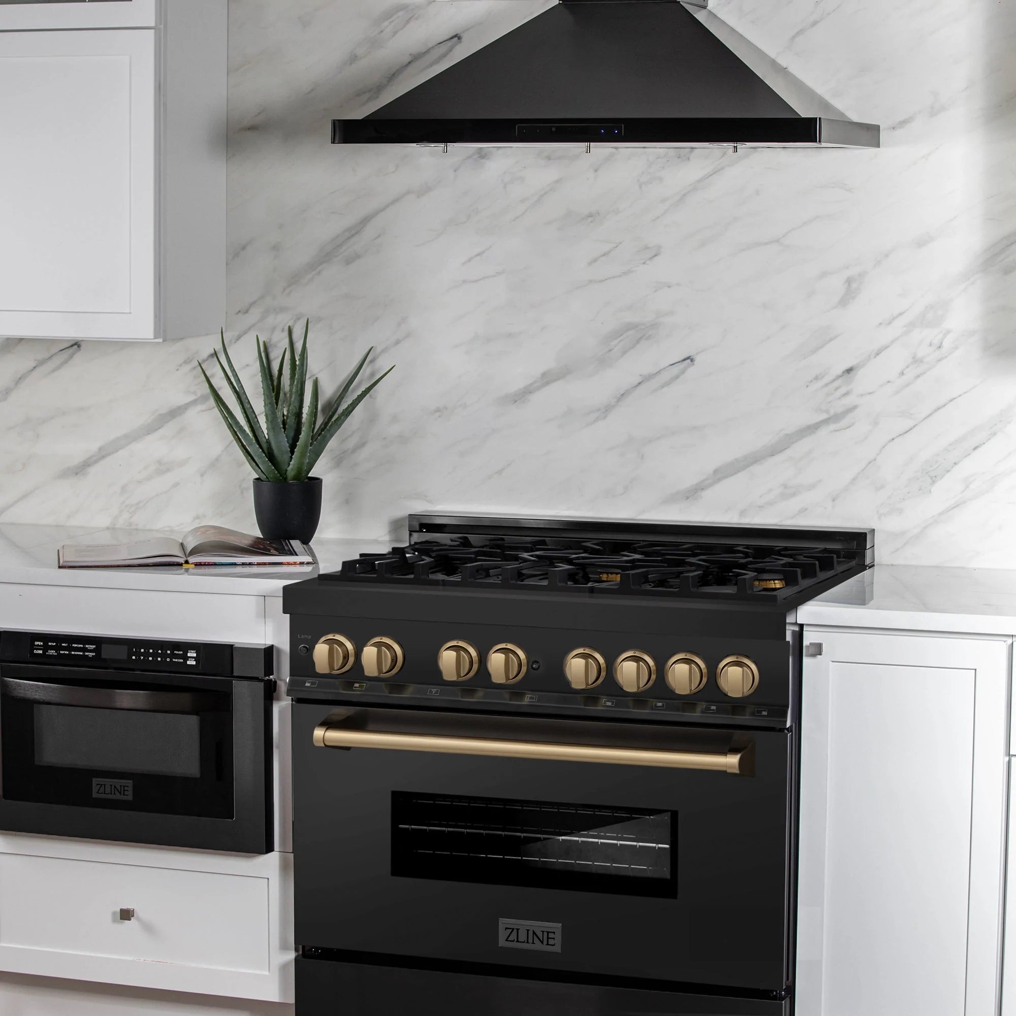 Black dual fuel range with champagne bronze knobs and overhead wall hood