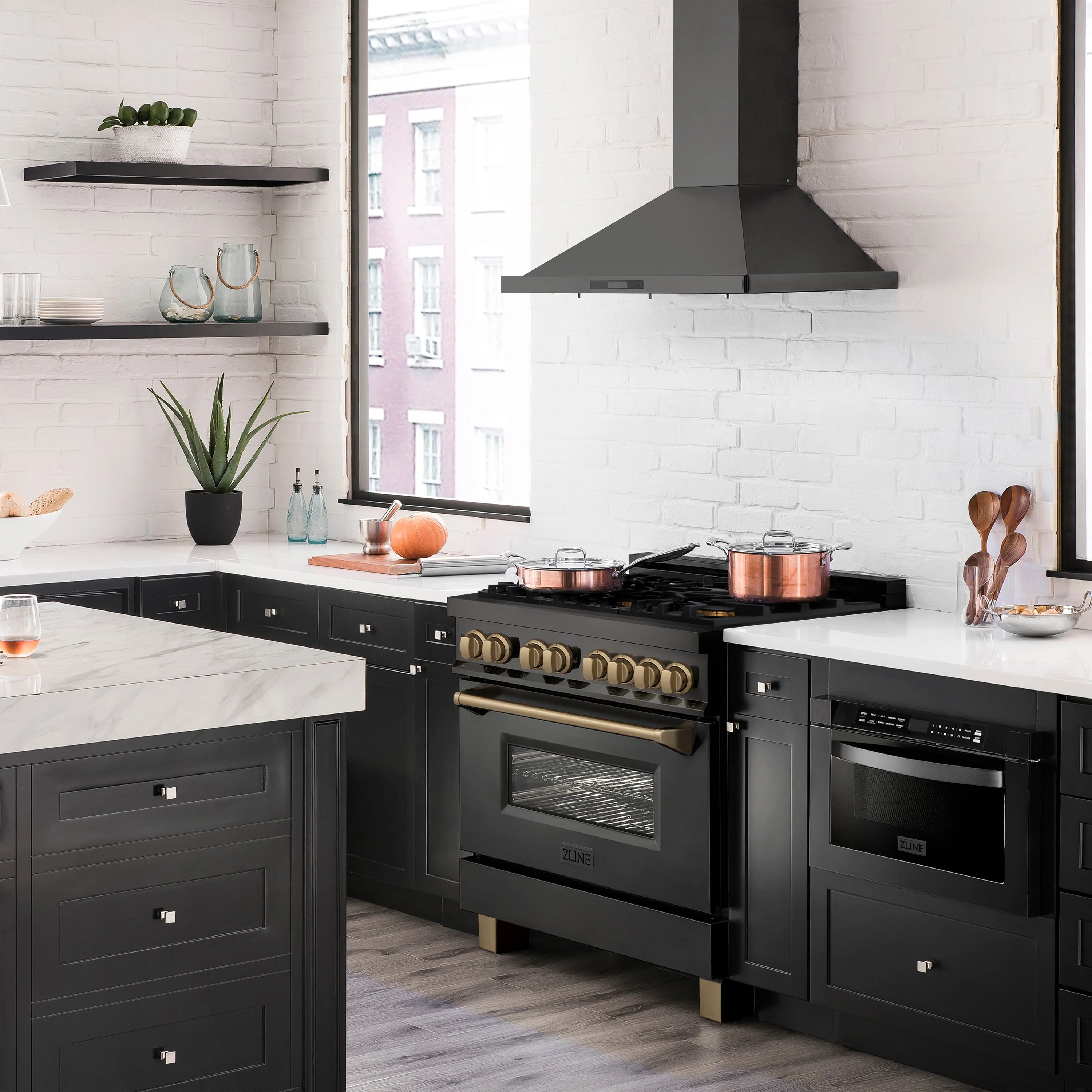 Dual fuel range in black stainless steel with champagne bronze trim, installed in modern kitchen
