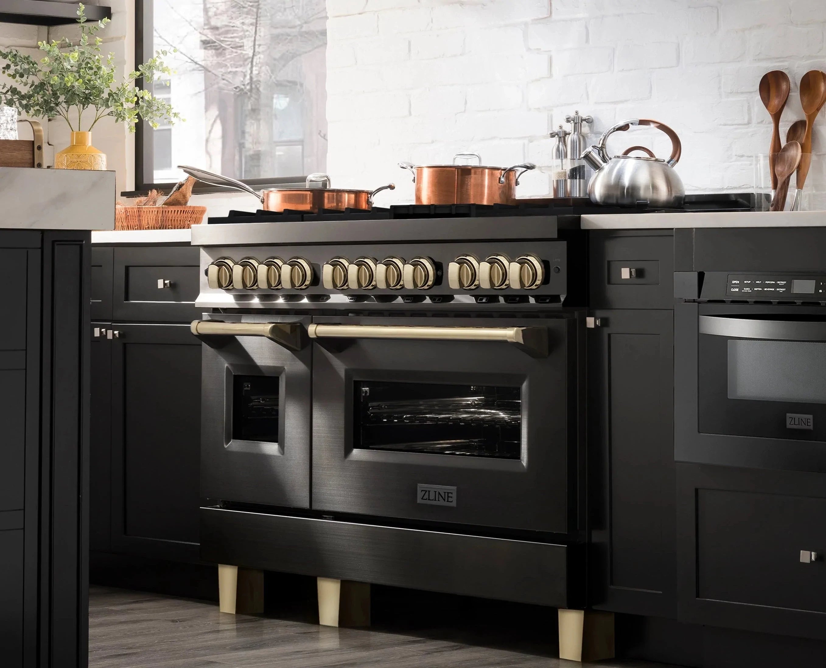 Black dual fuel range with gold knobs and open burners