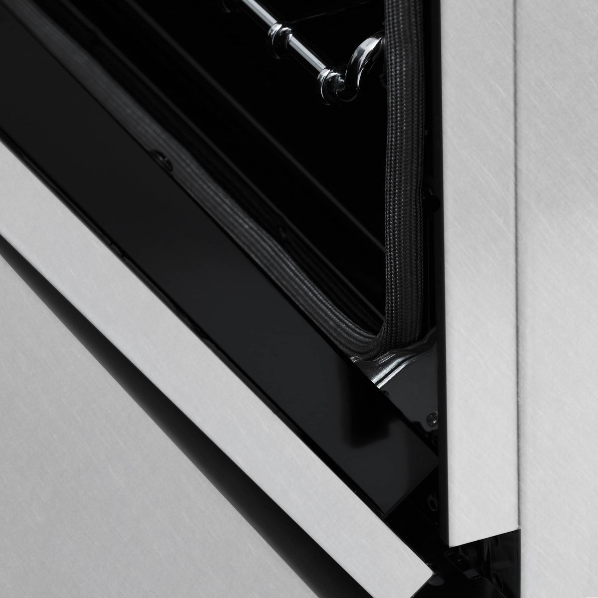 Electric oven rack rails and door opening inside a stainless oven cavity
