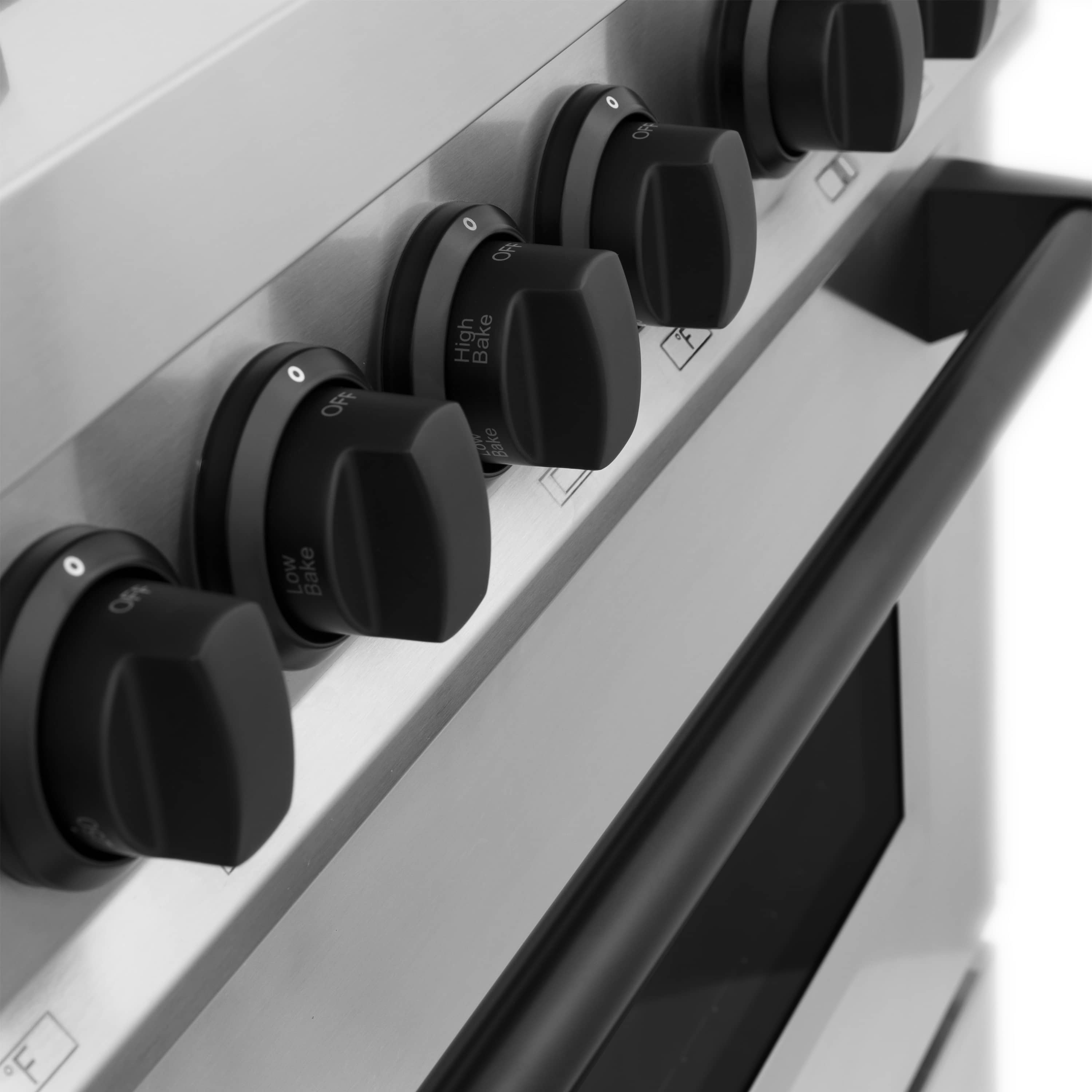Row of matte black dual fuel range control knobs along the cooktop