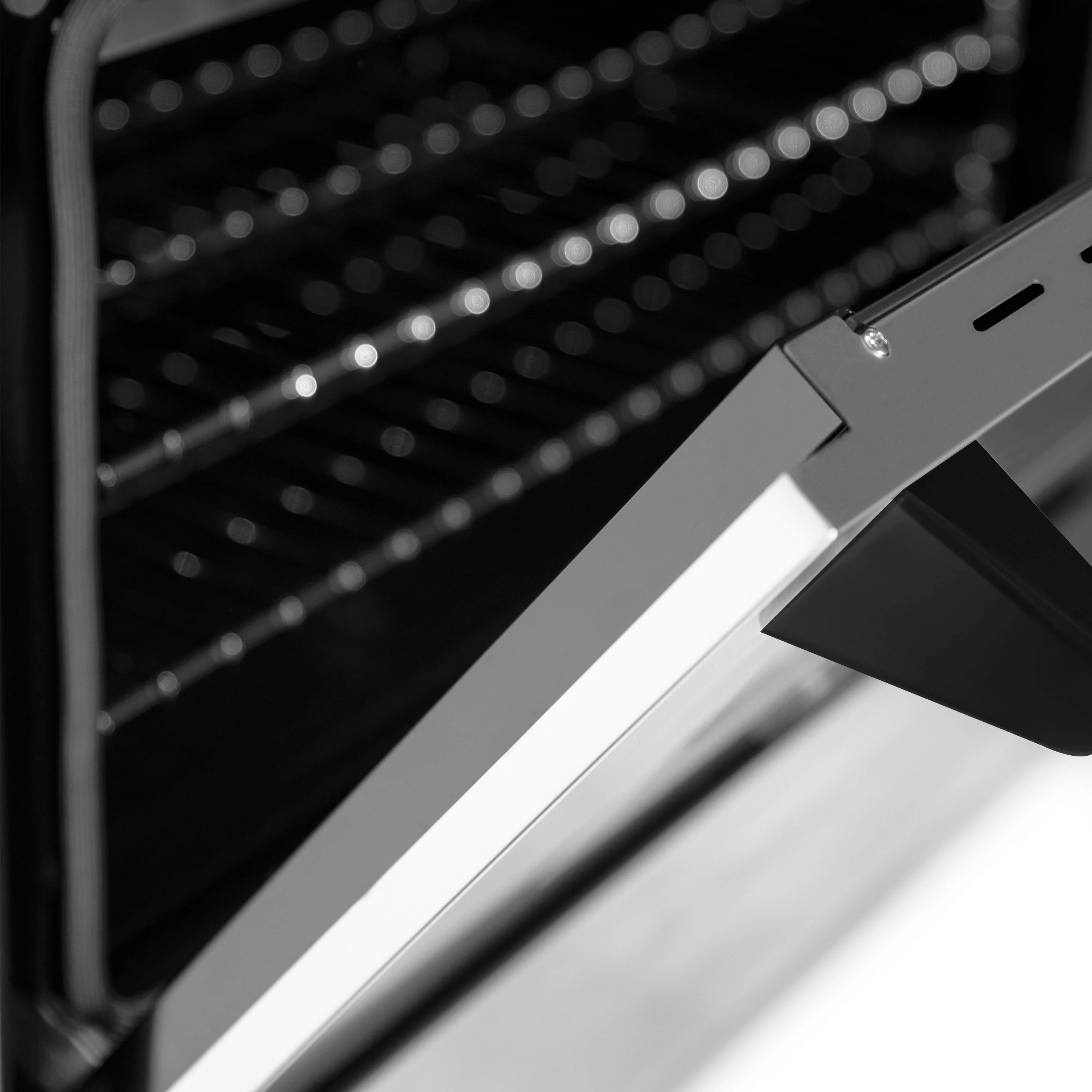 Stainless steel oven control trim with black accents and handle detail