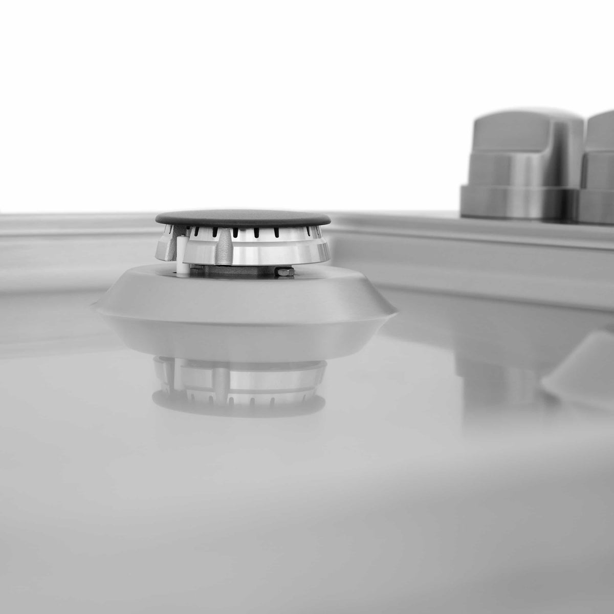 ZLINE gas cooktop burner head with black cap and silver igniter base