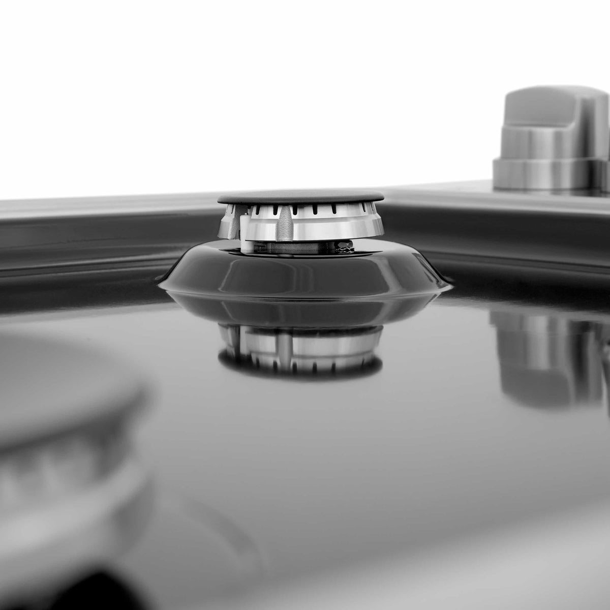 Black gas burner cap centered on a ZLINE black porcelain cooktop surface