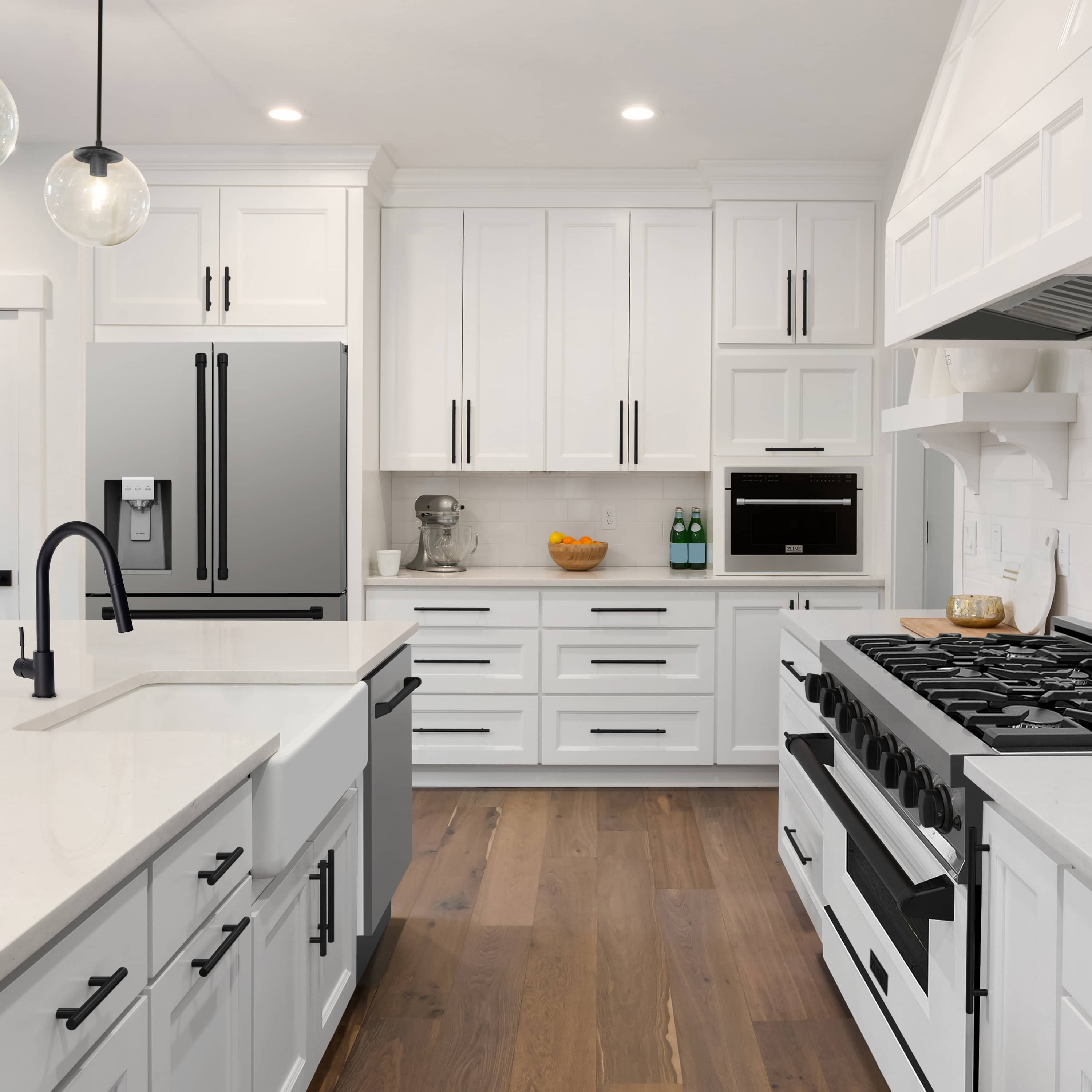 Stainless steel refrigerator in a white kitchen with double black handles and water dispenser