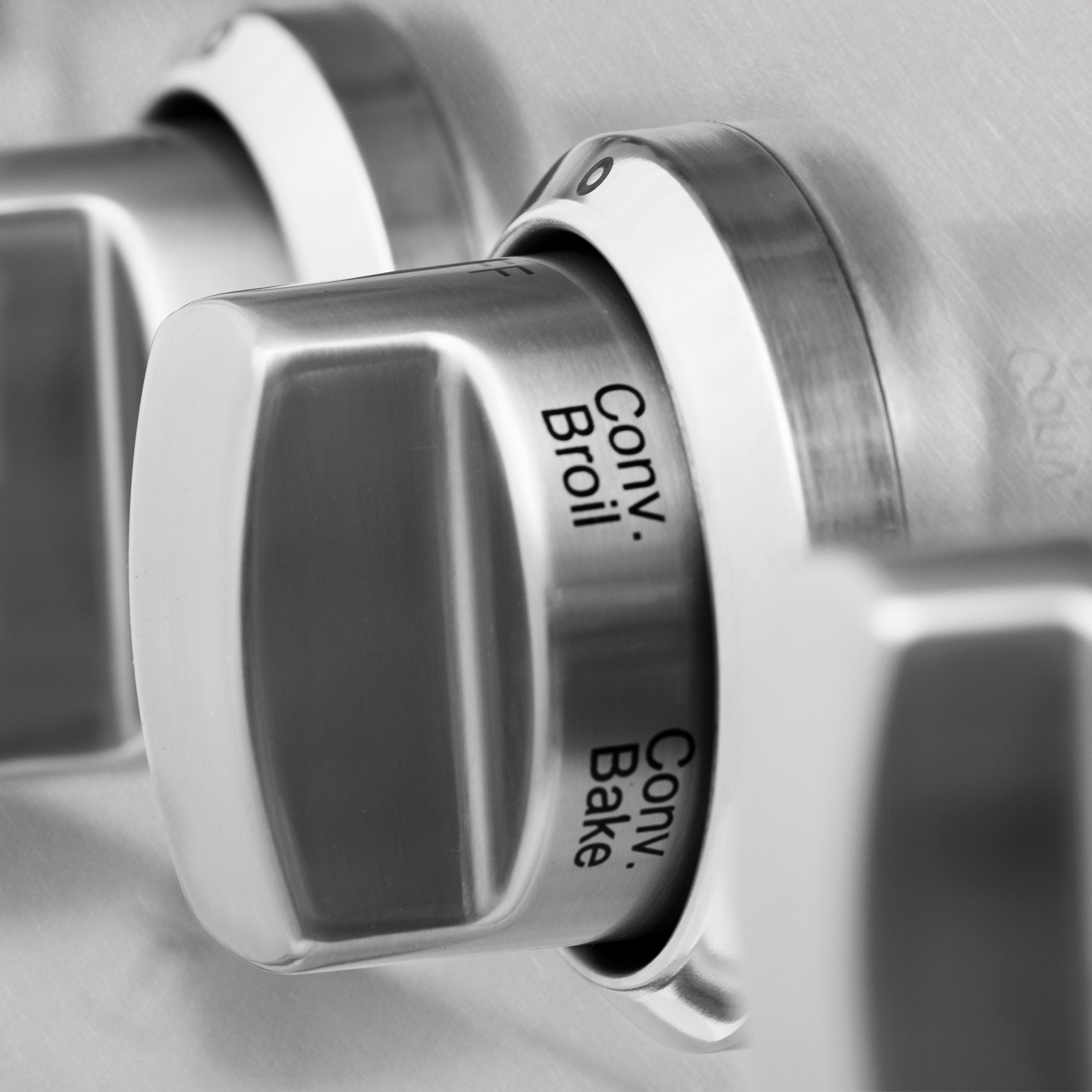 Stainless oven control knob labeled Broil and Bake