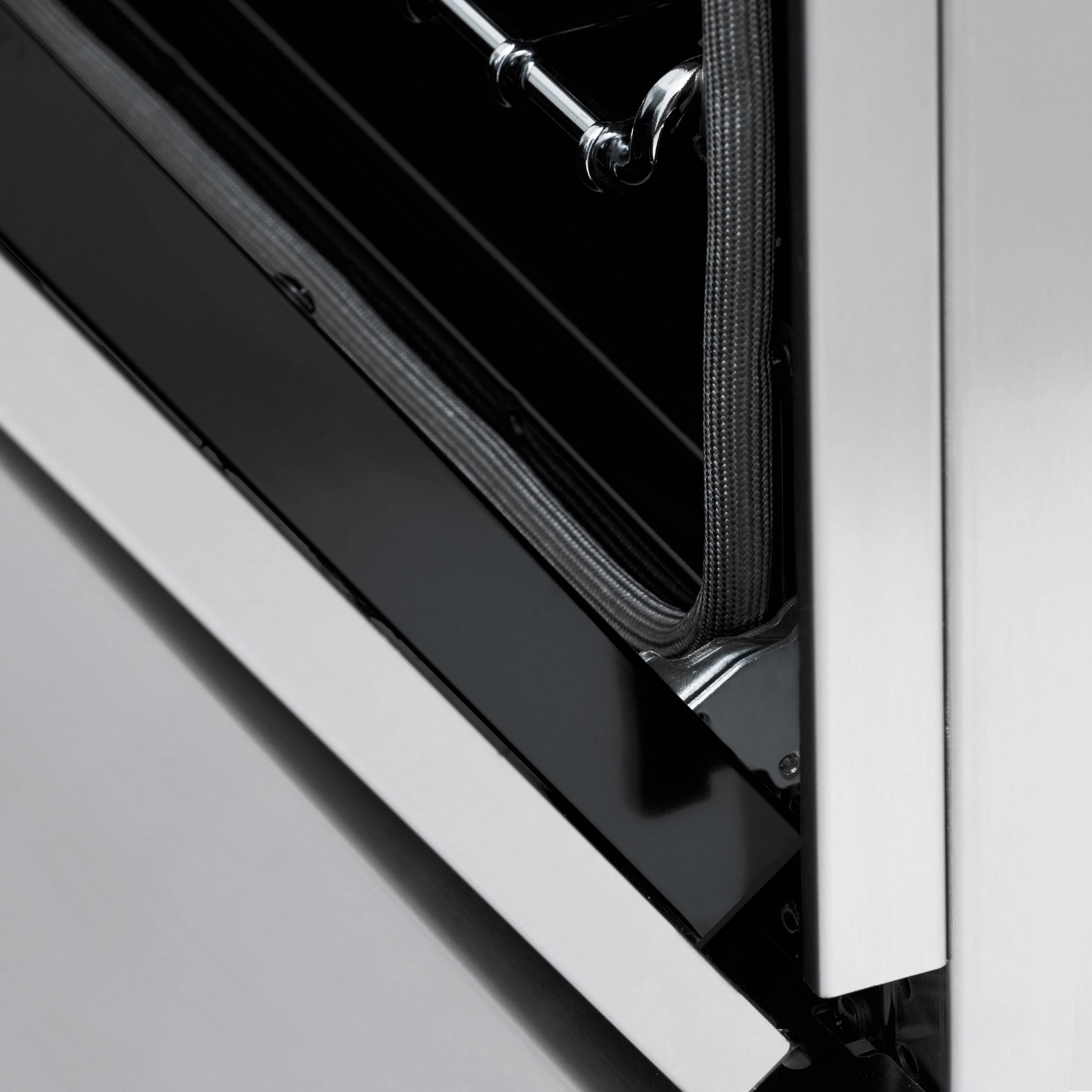 Oven door handle area with gold accents and black trim panel