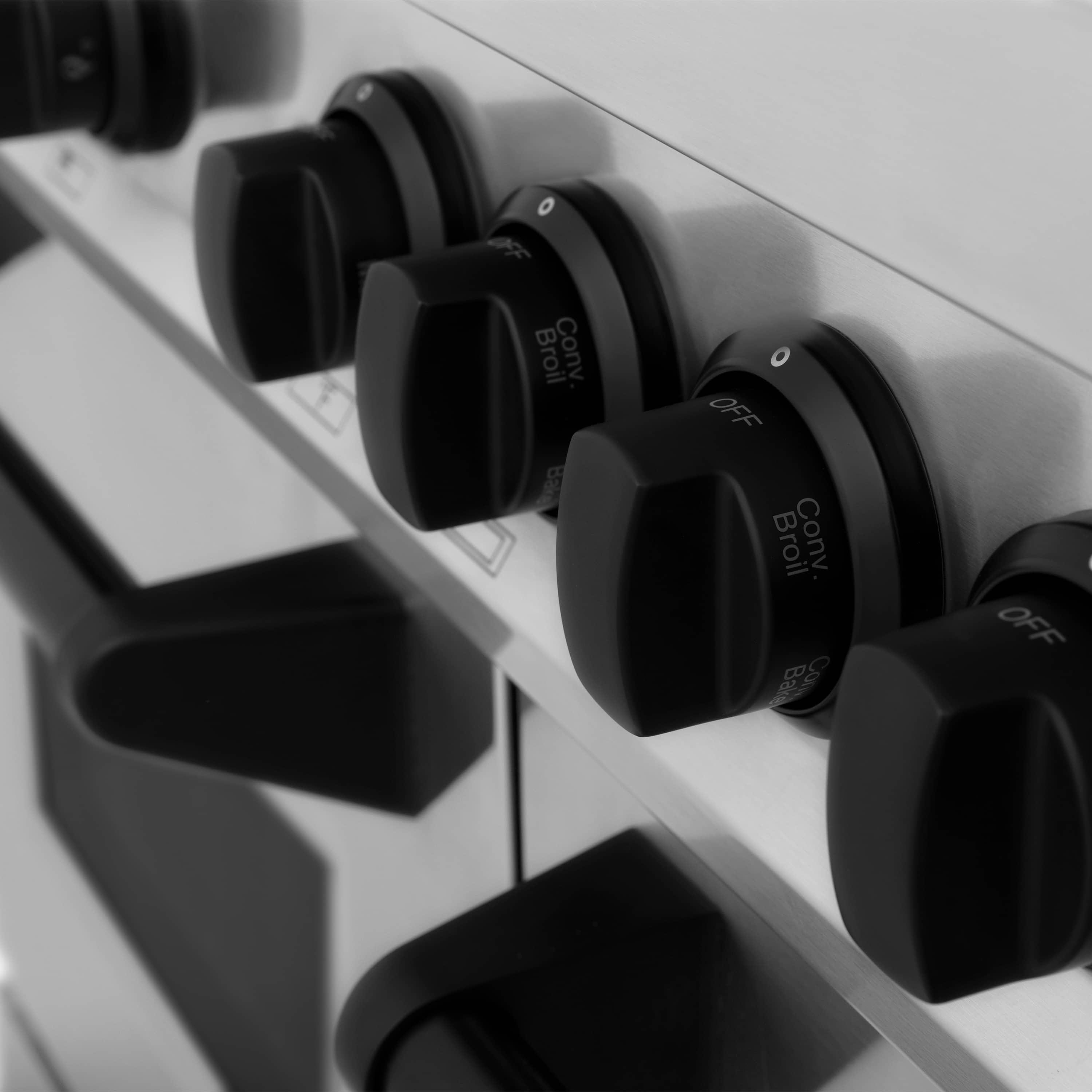 Dual-fuel range control knobs with OFF markings and glossy black finish