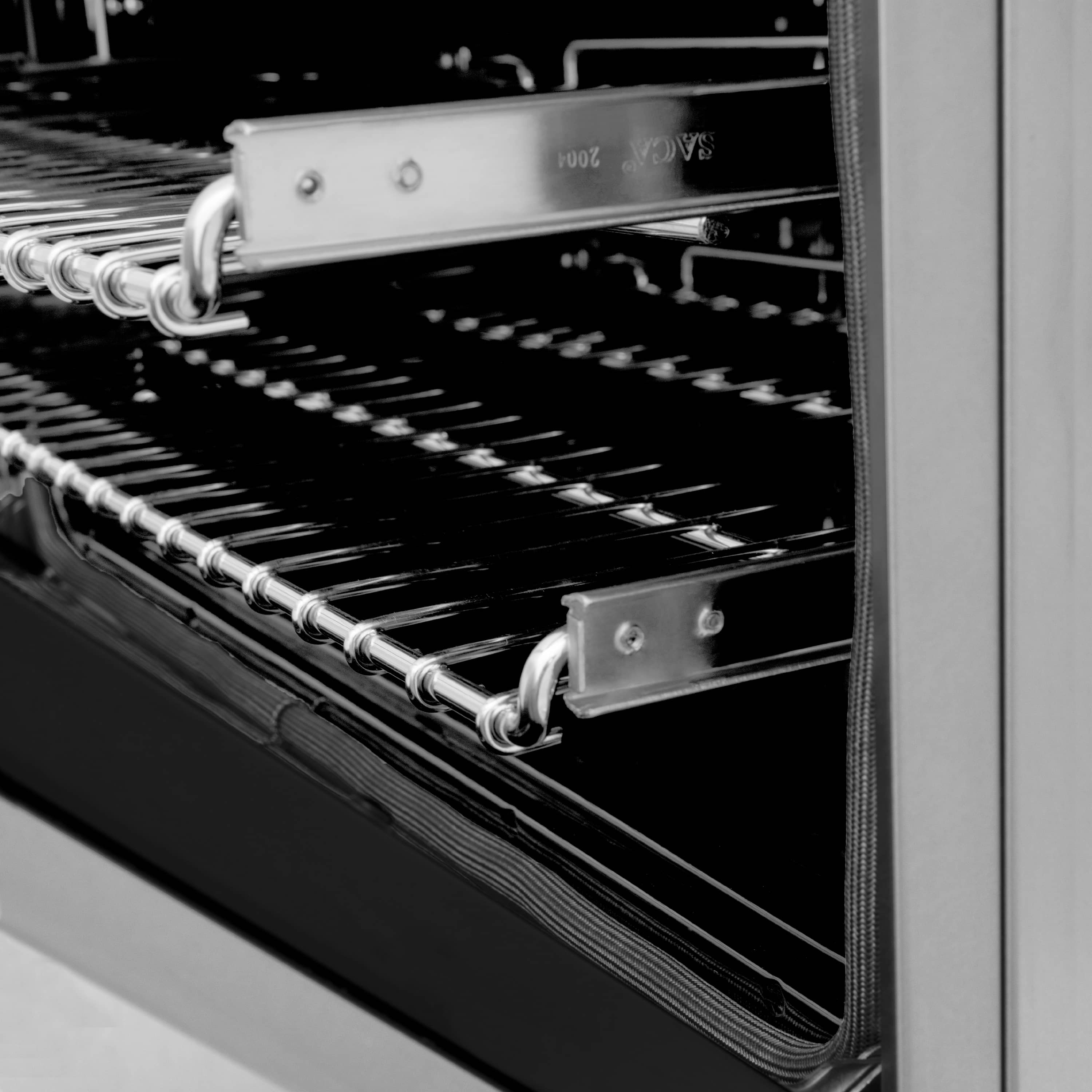 Dual-fuel range oven interior with heating element and chrome rack rails
