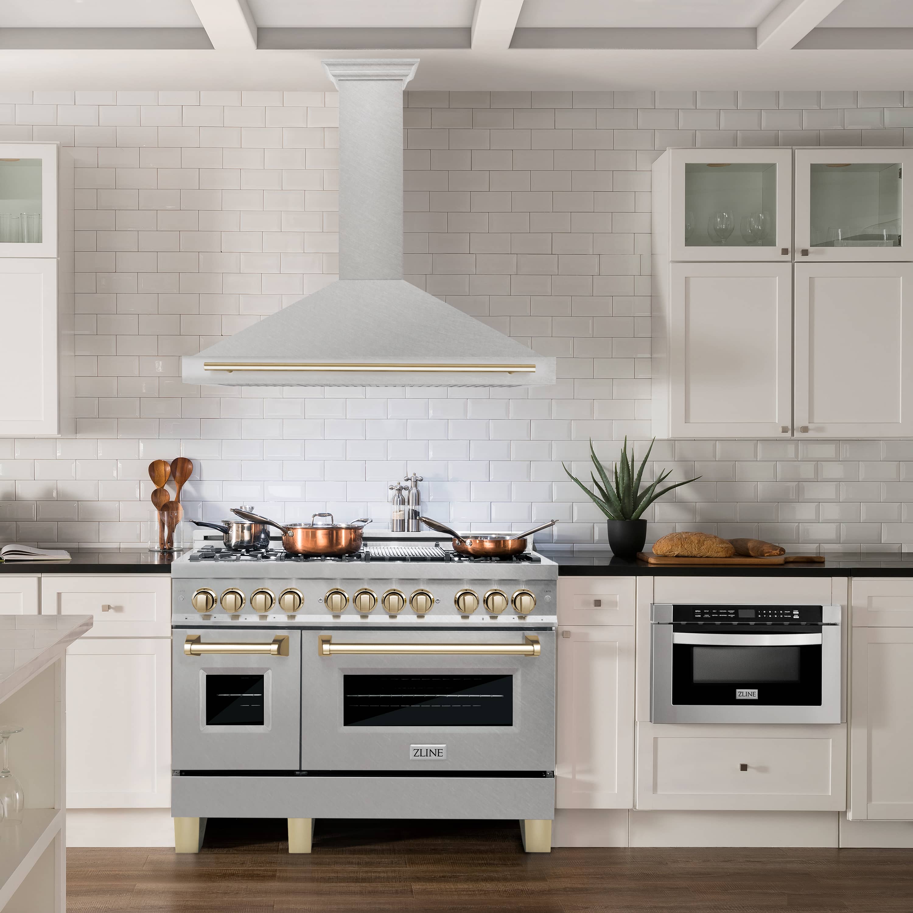 Wall-mounted range hood chimney with satin stainless steel and gold trim bar