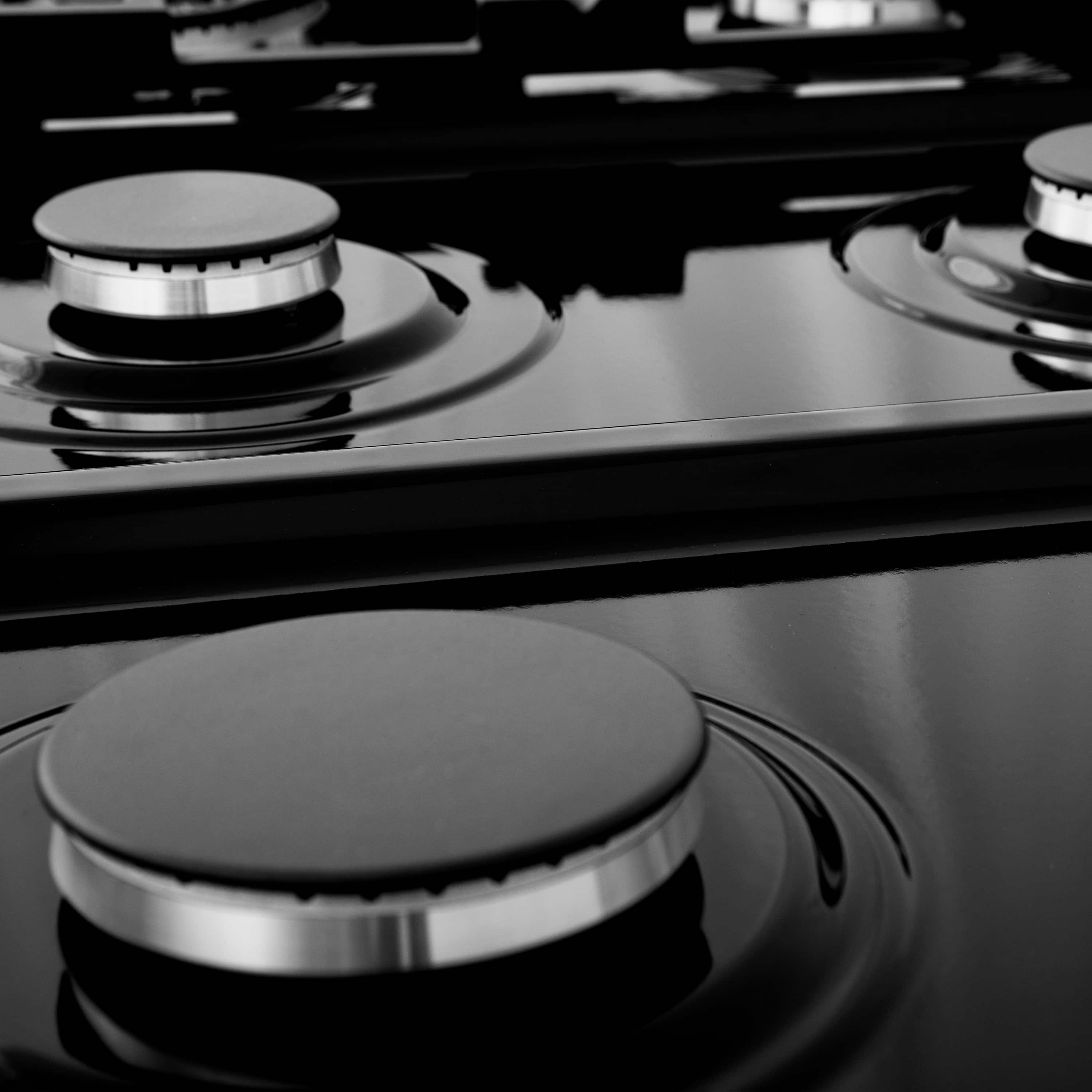 Dual fuel range cooktop with black burner caps and smooth stainless control panel