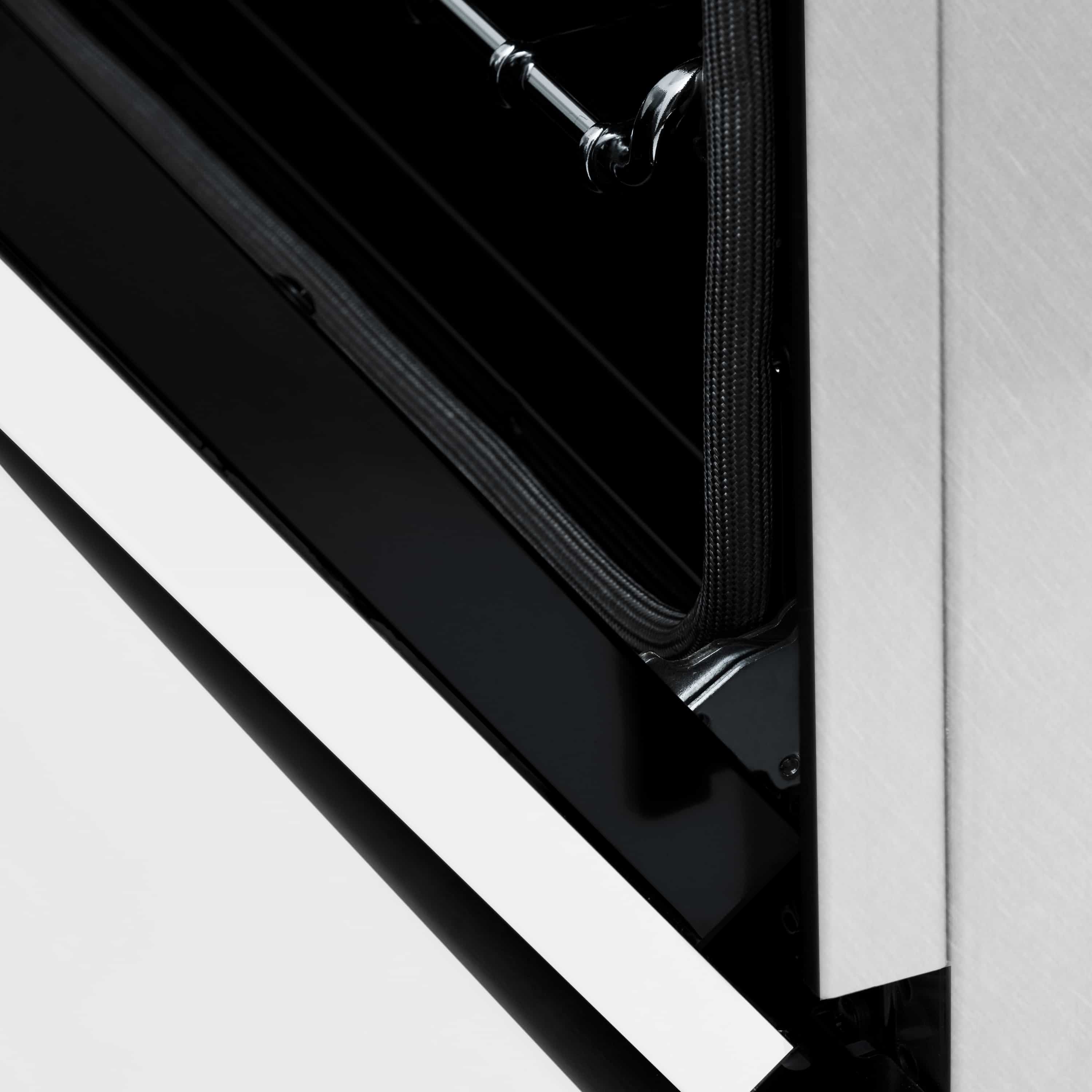 Dual fuel range corner with black cooktop surface and white matte door panel