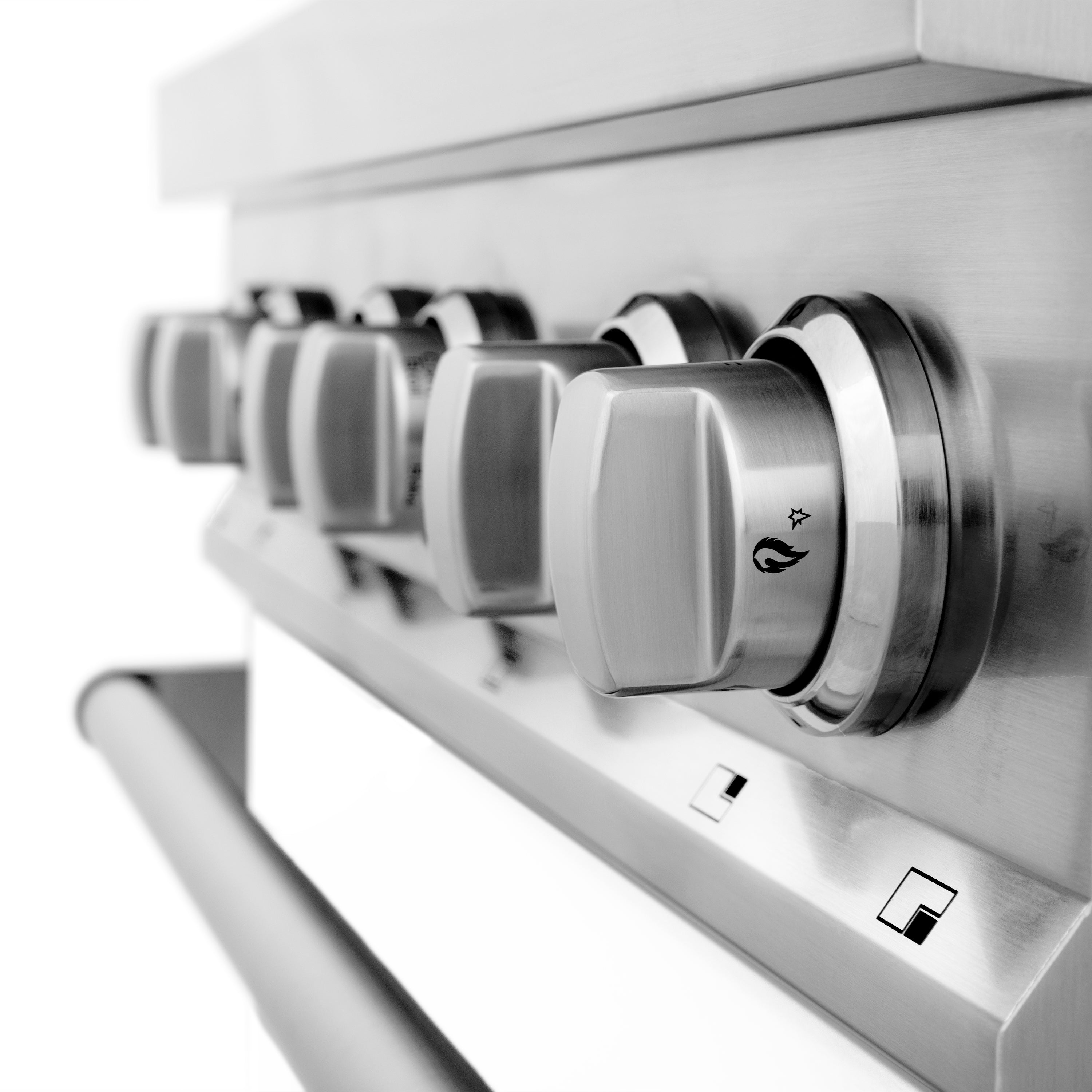 Brushed stainless steel control knobs and burner grates on a dual fuel range