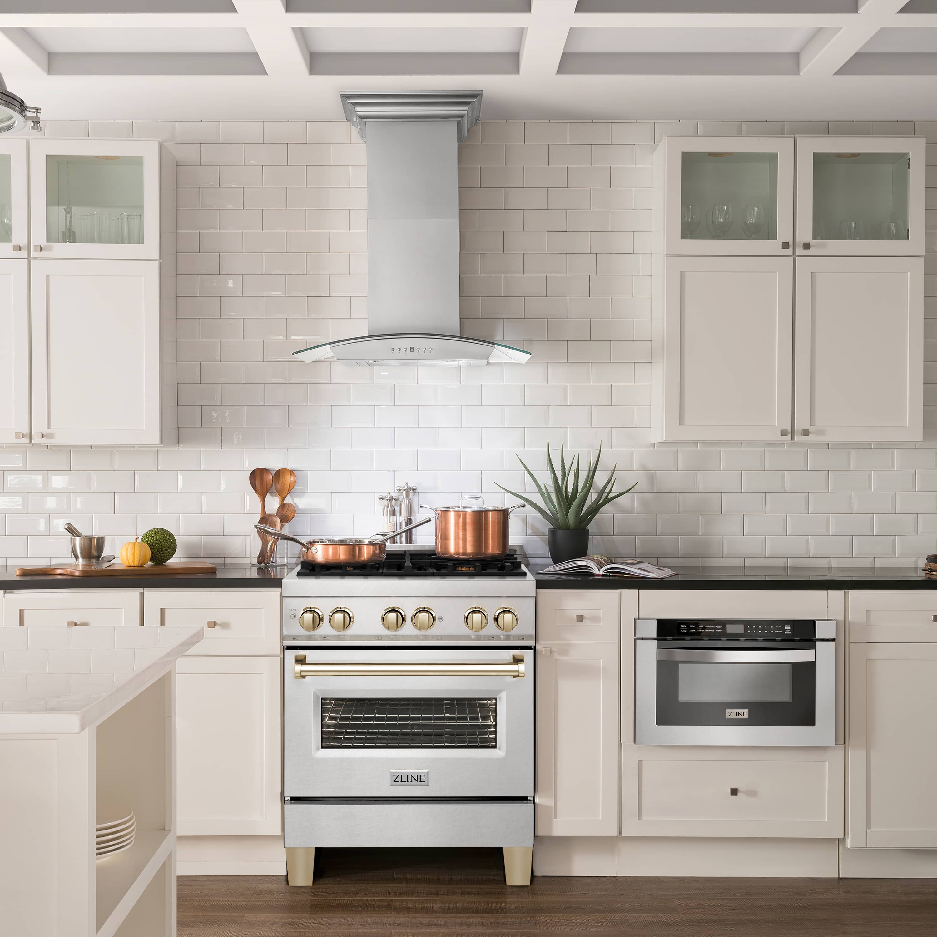 Satin stainless gas range with gold control knobs and electric oven window