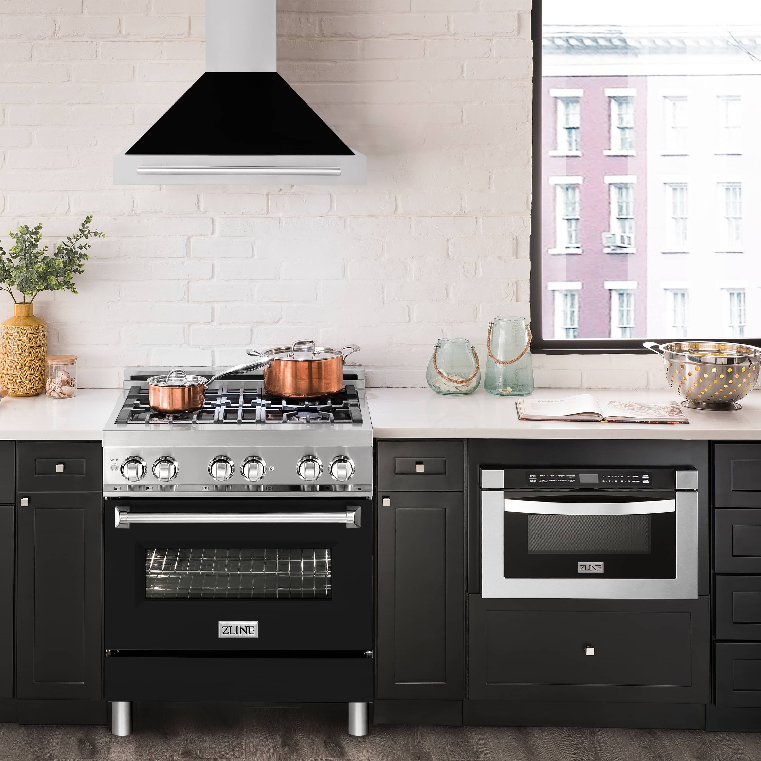 Wall range hood above cooktop with black matte canopy, white chimney, stainless control panel