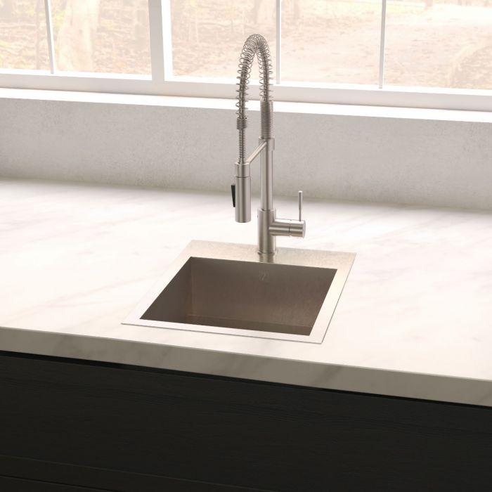 Stainless steel single-bowl sink installed on countertop with tall faucet