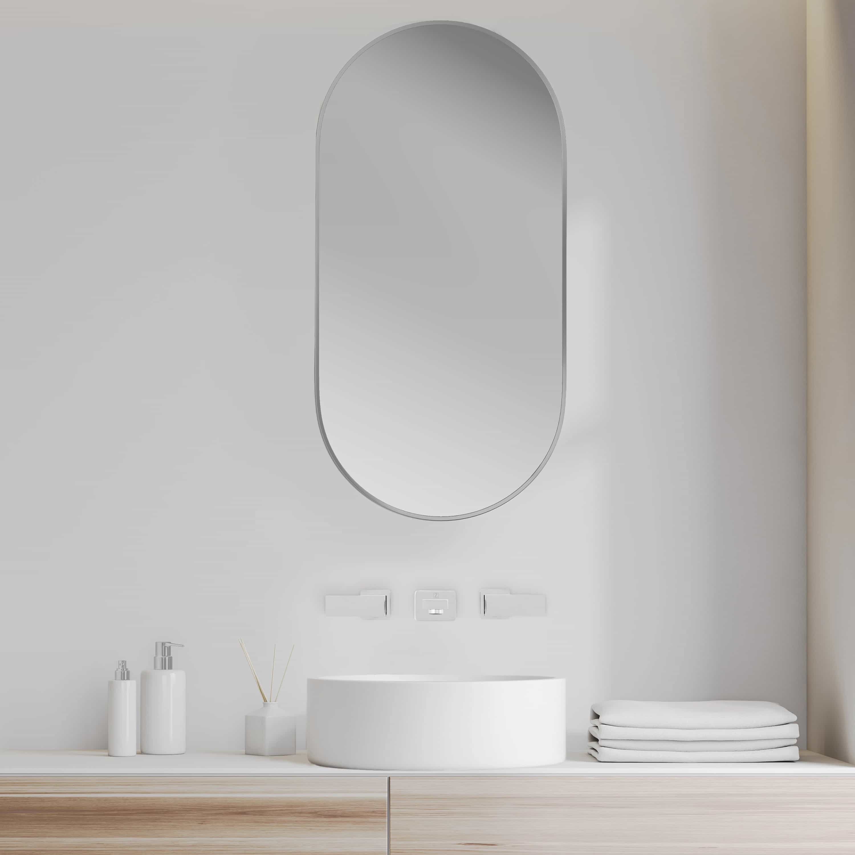 Matte white round vessel bath sink on vanity with wall-mounted faucet
