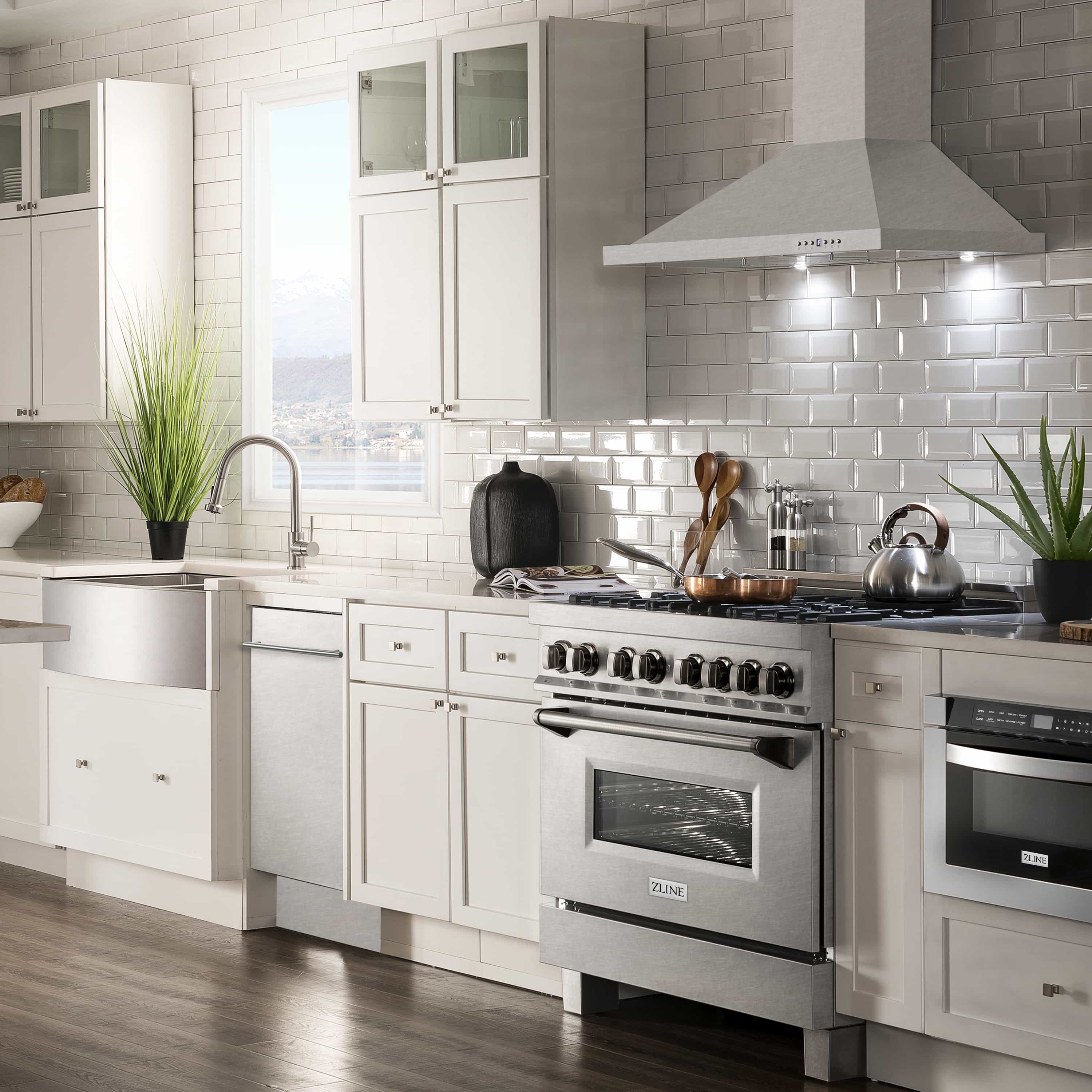 Stainless steel built-in dishwasher installed in modern kitchen with white cabinetry
