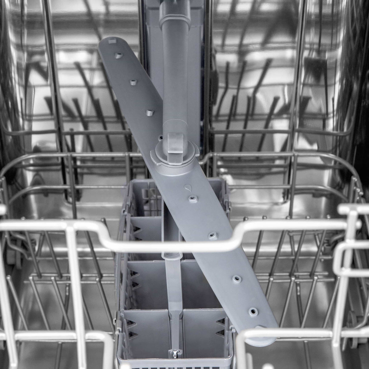 Dishwasher interior close-up of lower rack and spray arm assembly
