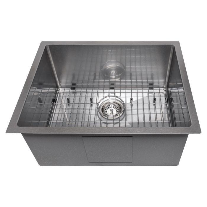 Single-bowl stainless steel sink interior with bottom grid and round drain.