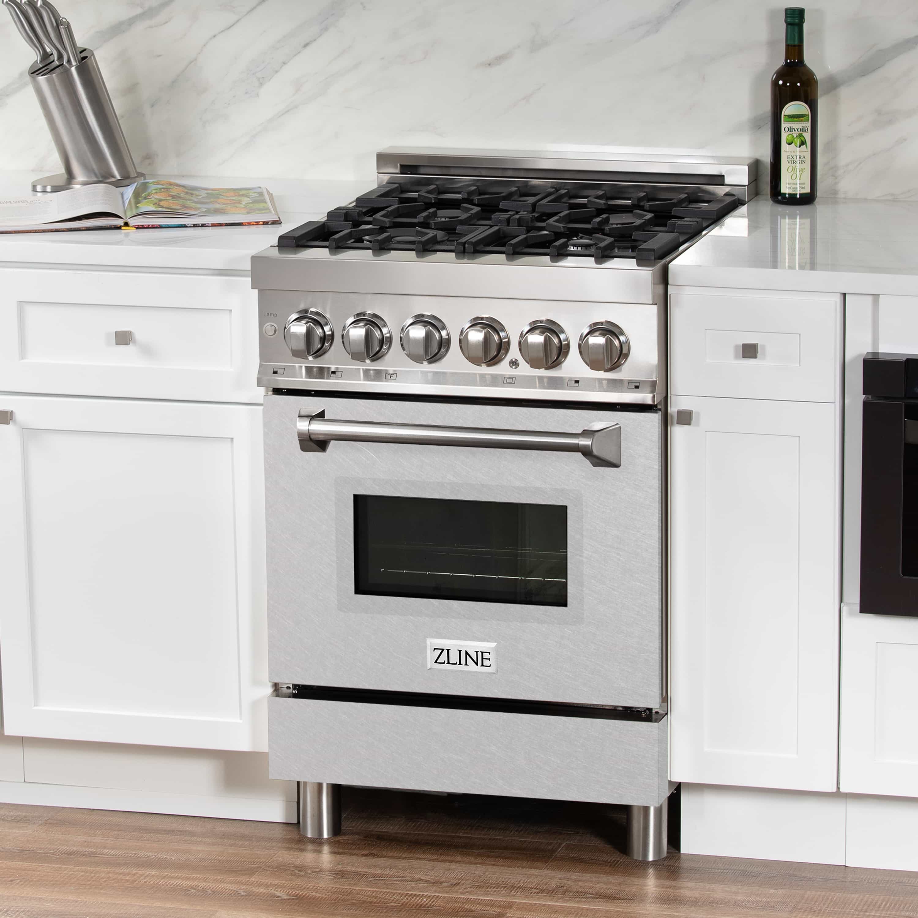 Stainless steel dual fuel range front view with knobs, burner grates, and oven window