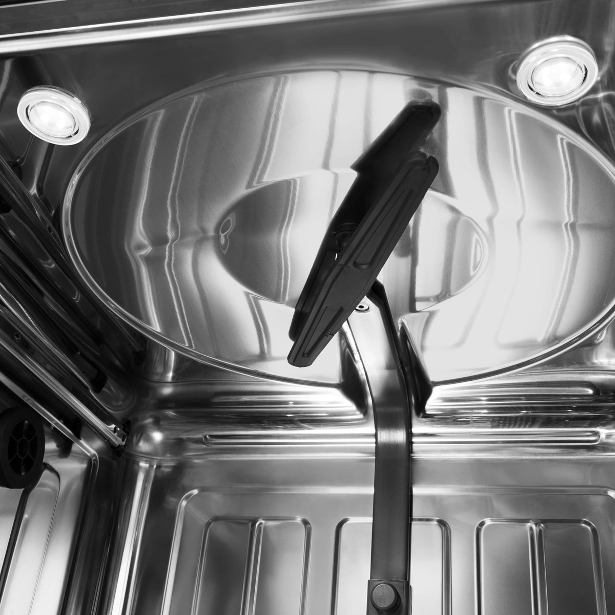 Stainless steel dishwasher tub interior with spray arm and circular base