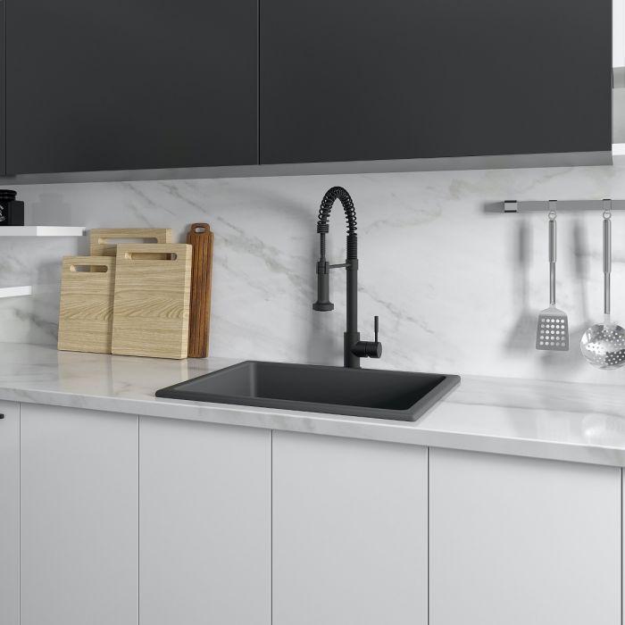 Charcoal single-bowl kitchen sink installed with black faucet and countertop