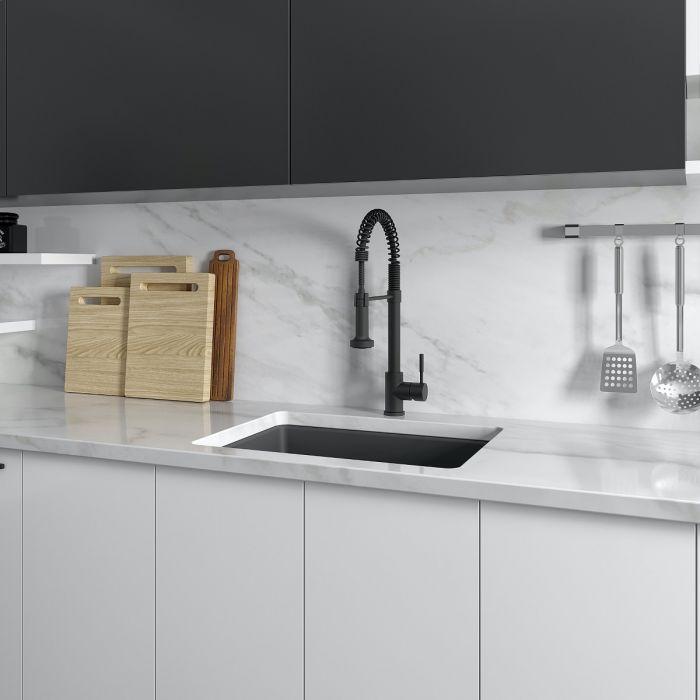 Charcoal single-bowl kitchen sink installed with black faucet and stainless accessories