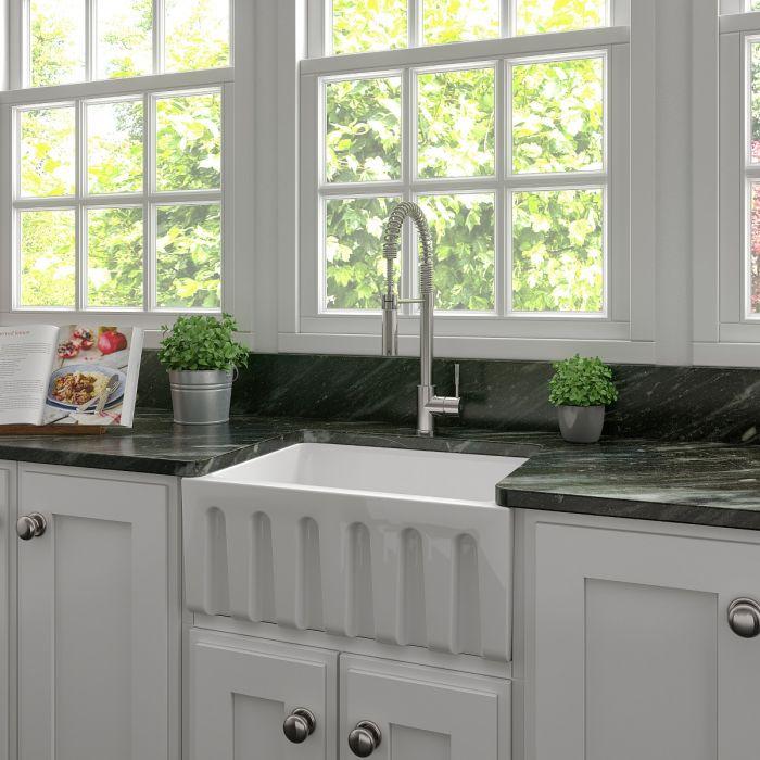 White farmhouse apron-front fireclay kitchen sink, single bowl with integrated backsplash ledge
