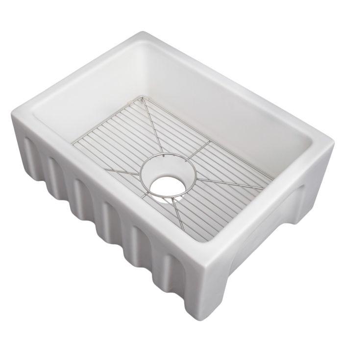 White farmhouse apron-front sink showing bottom grid and raised front panel